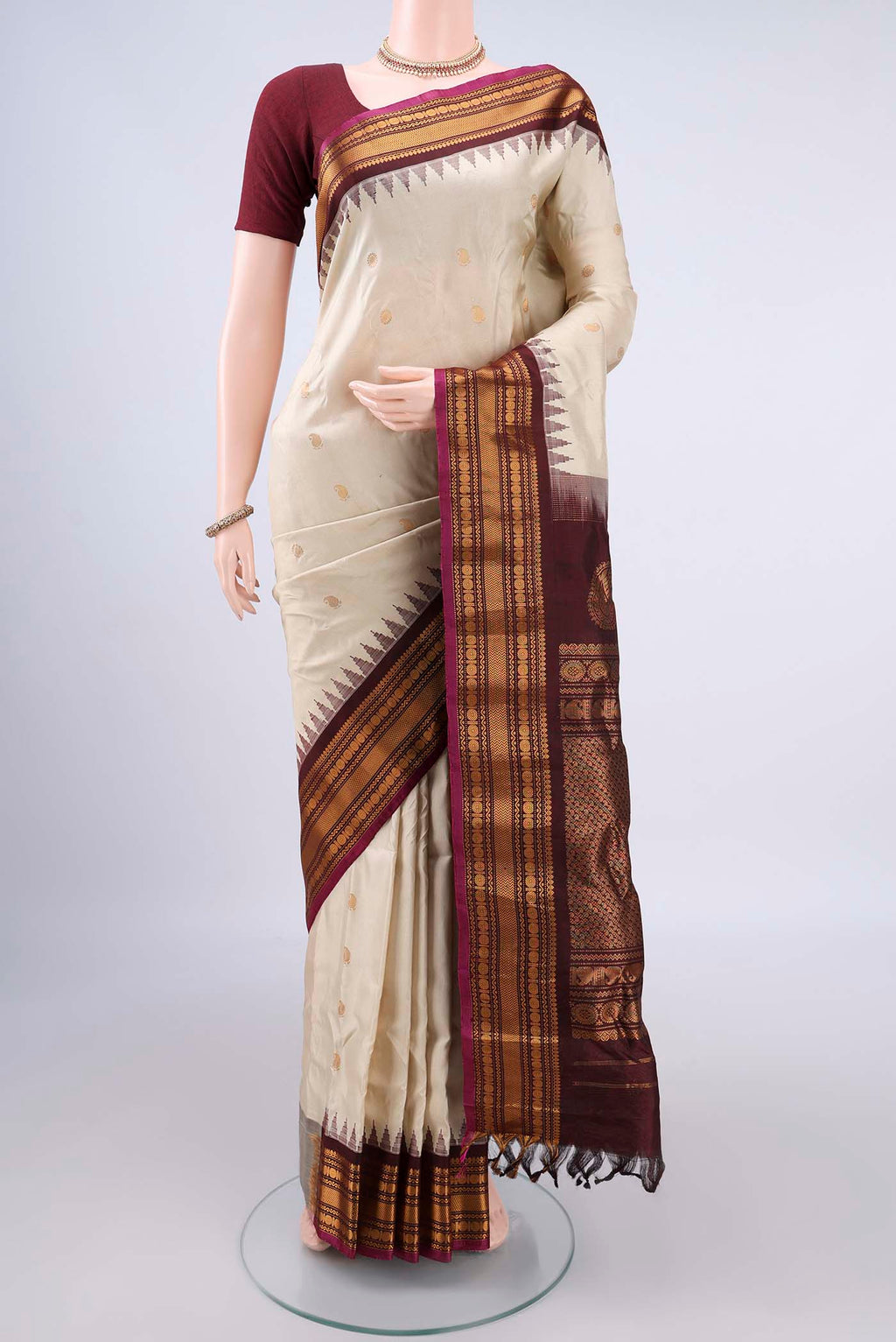 Pure Silk Cream Gadwal Saree with Zari Butta on the body and Zari Border.  displayed on a mannequin