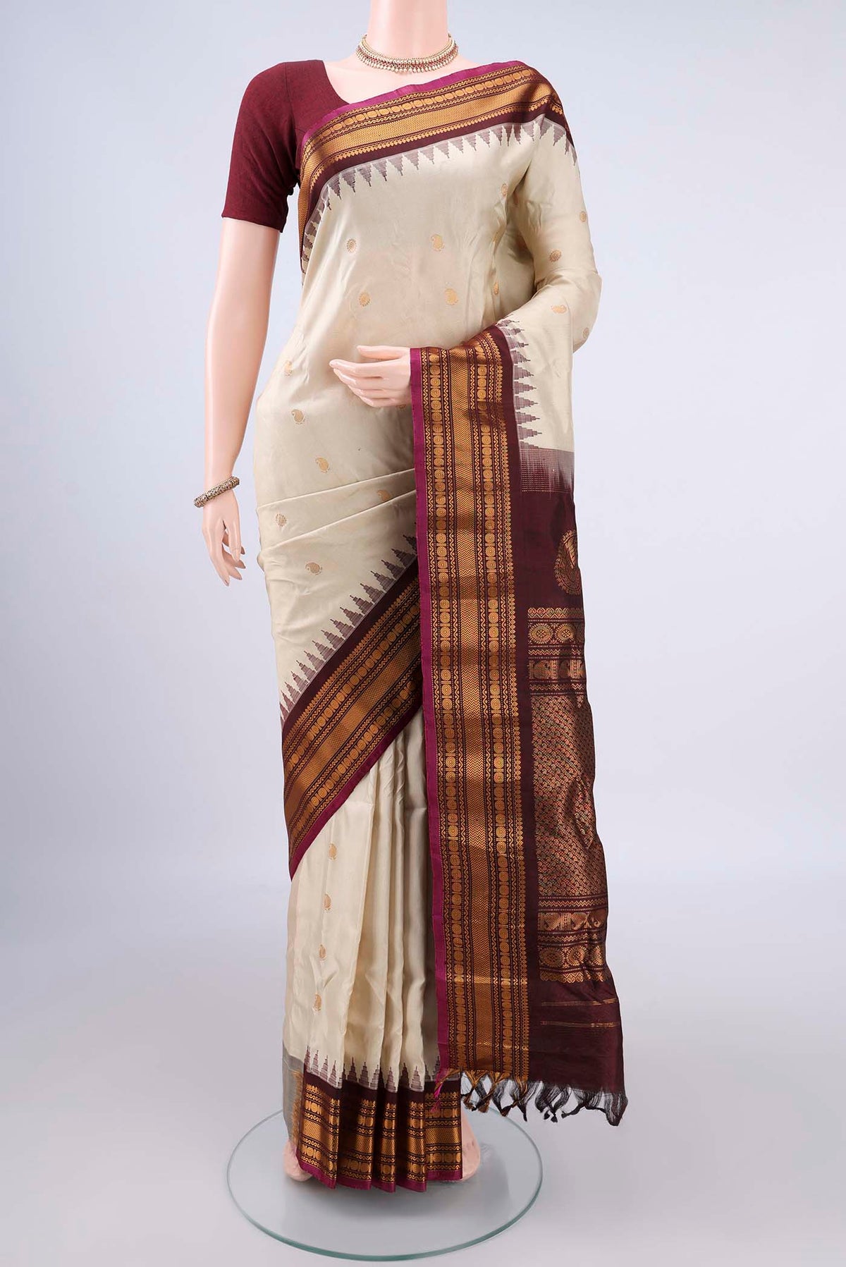 Pure Silk Cream Gadwal Saree with Zari Butta on the body and Zari Border.  displayed on a mannequin