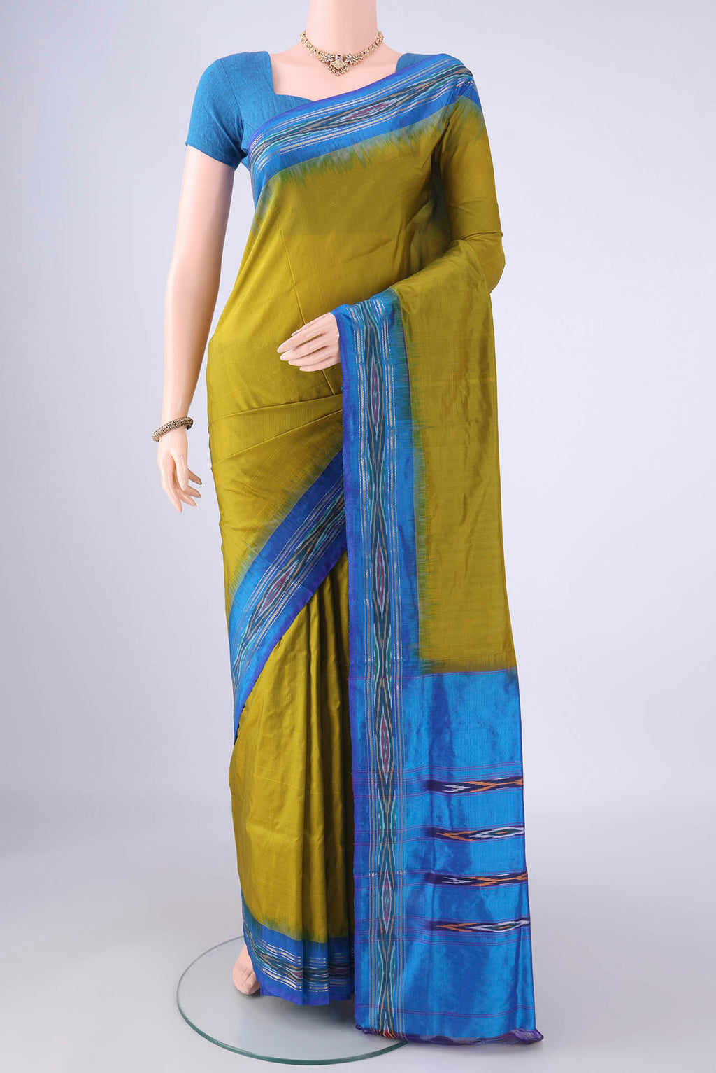 Mehandi Green Pochampally Silk Saree with Plain Body and Ikat Border.  displayed on a mannequin