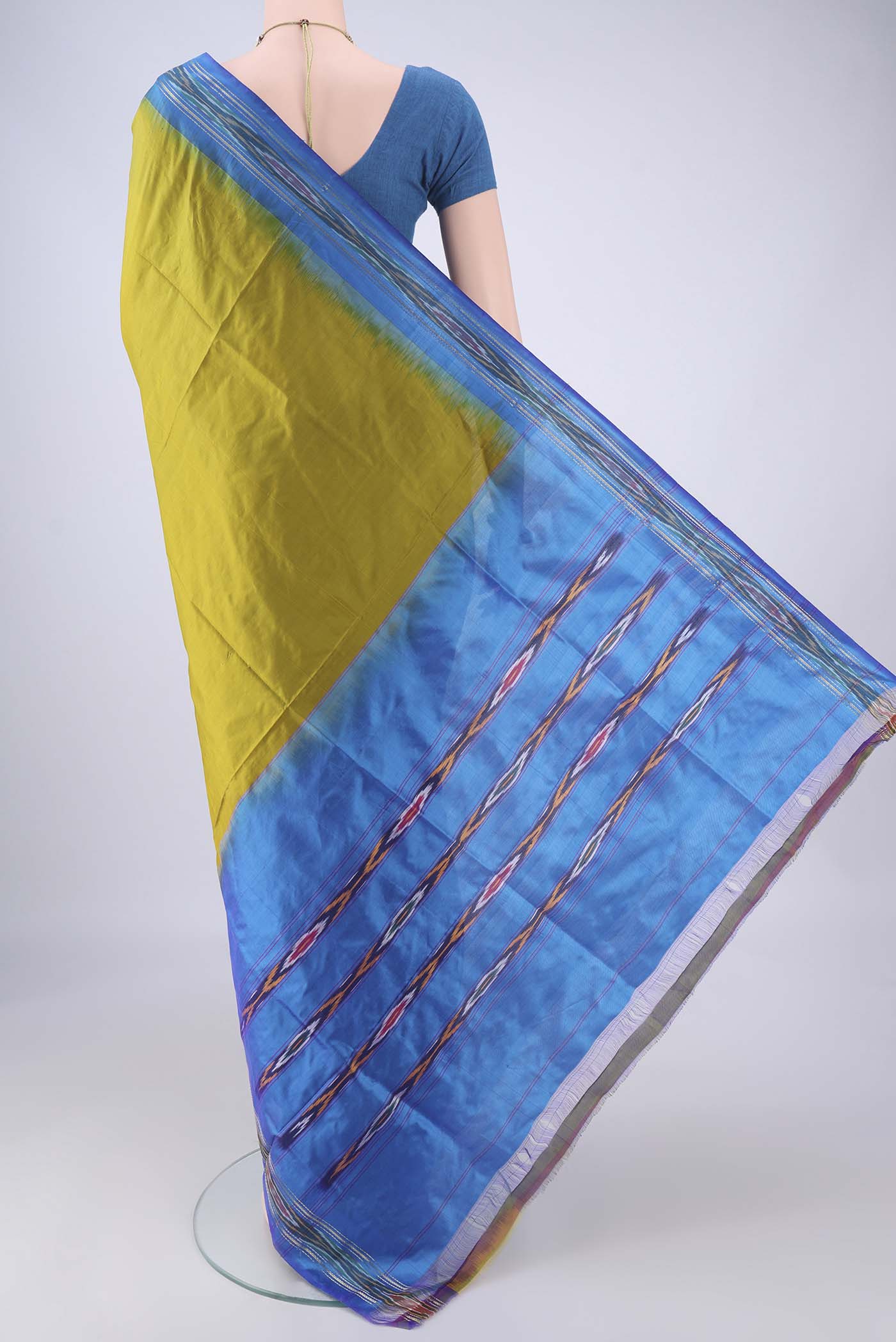 Flat view of Mehandi Green Pochampally Silk Saree with Plain Body and Ikat Border. 