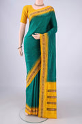 Bottle Green Pochampally Silk Saree with Plain Body and Ikat Border.  displayed on a mannequin