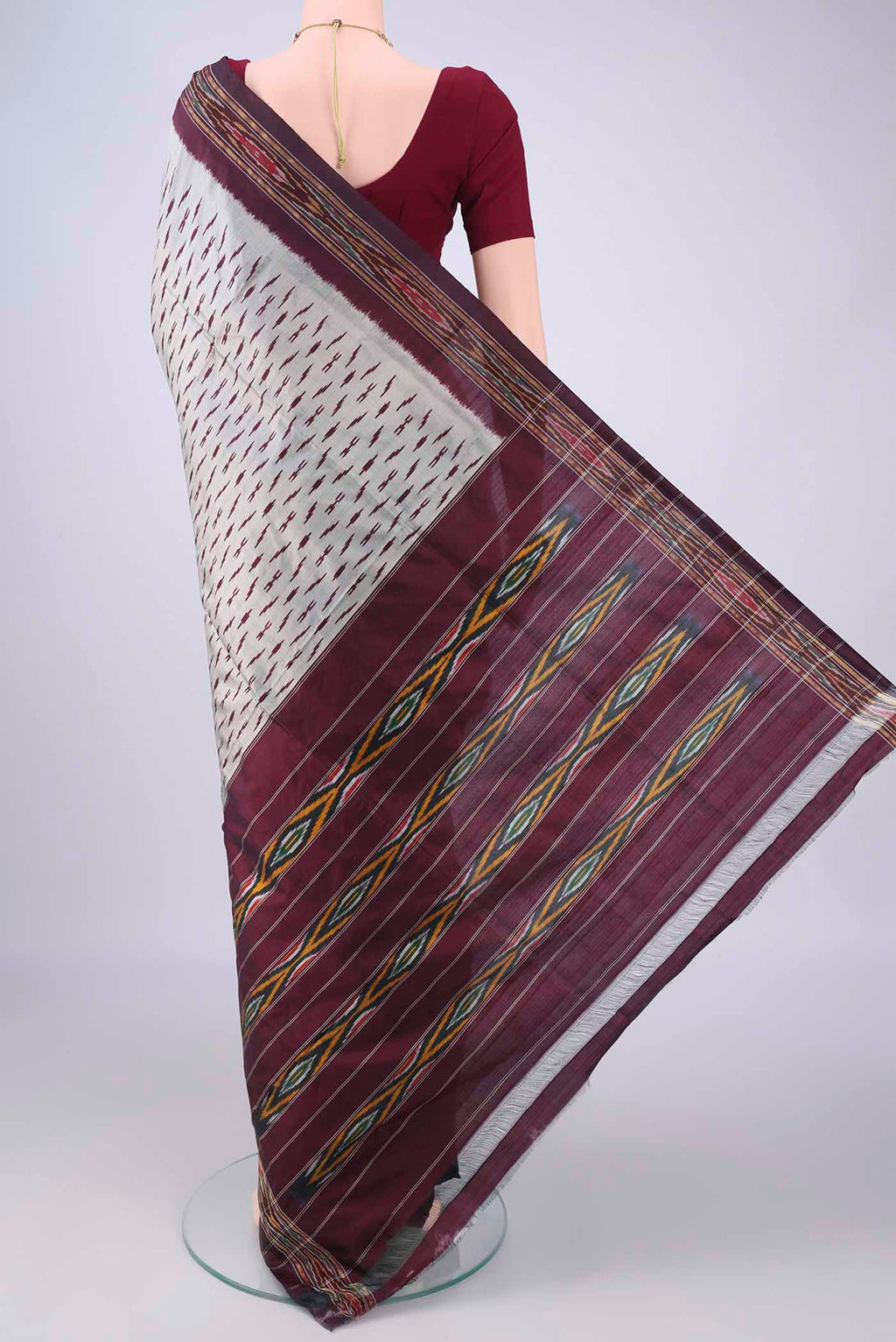 Flat view of Davys Grey Pochampally Silk Saree with Ikat design on the body and Ikat Border. 