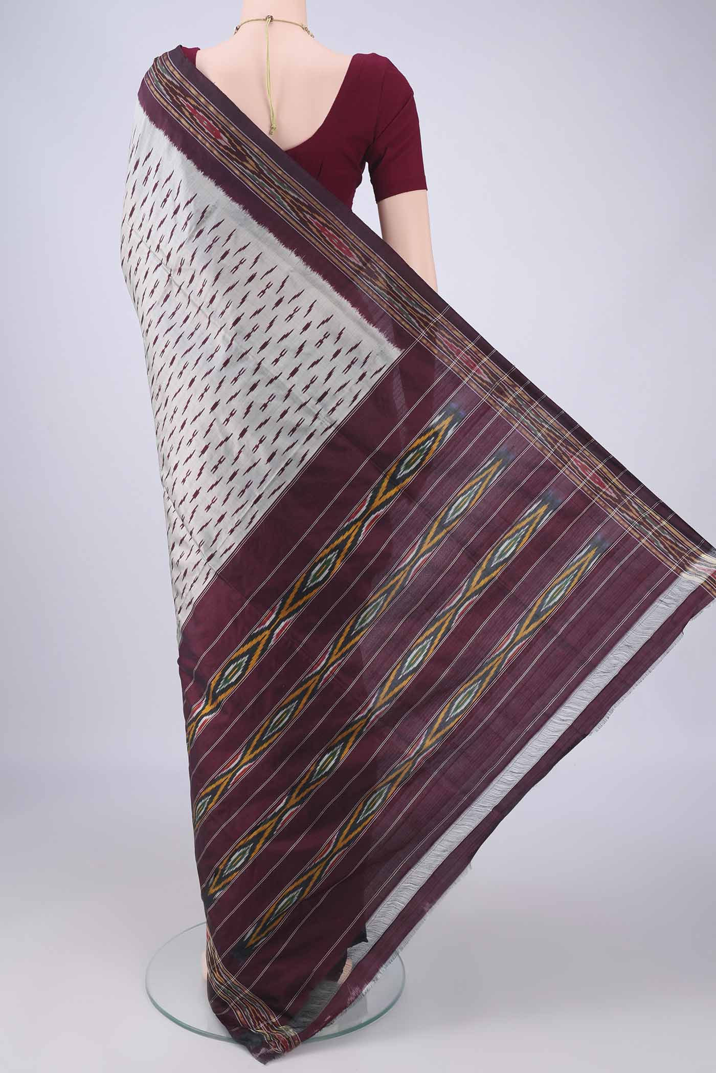 Flat view of Davys Grey Pochampally Silk Saree with Ikat design on the body and Ikat Border. 
