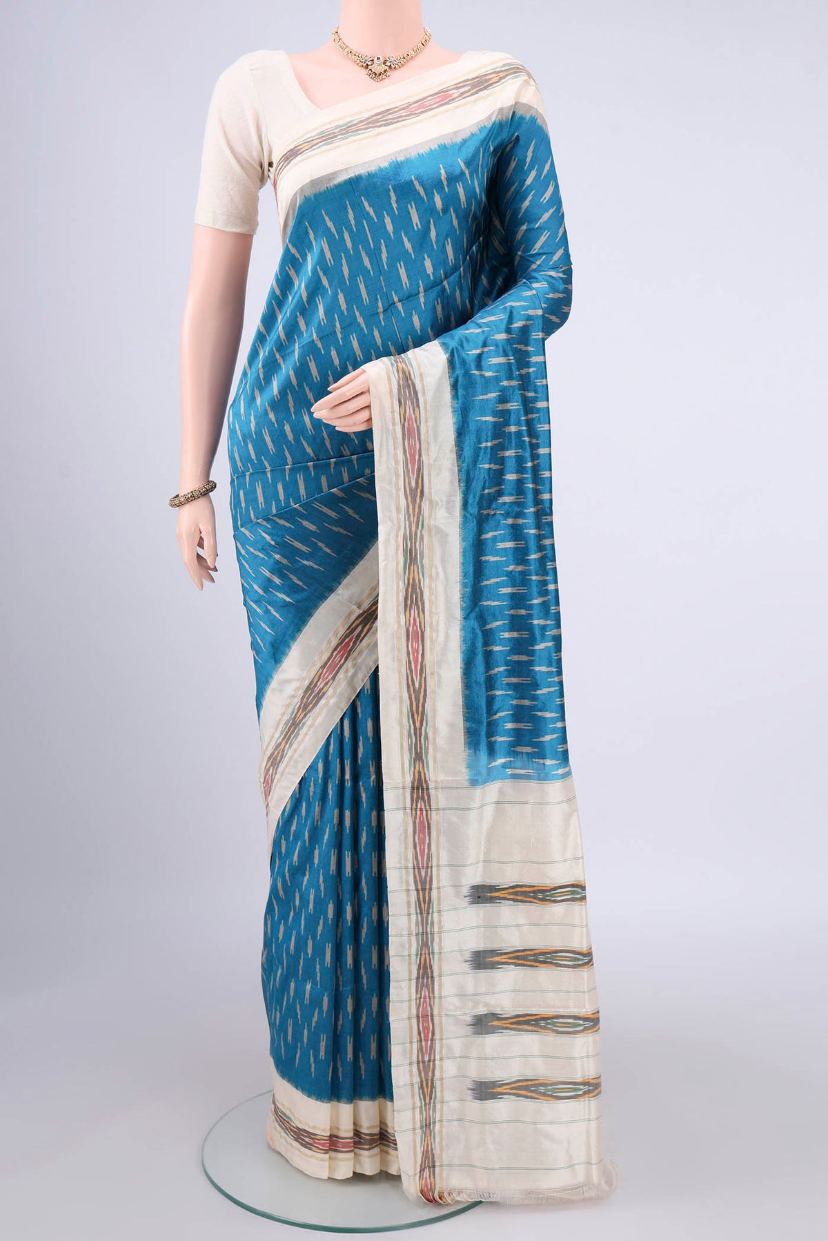 Pure Silk Blue Pochampally Saree with Ikat design on the body and Ikat Border.  displayed on a mannequin