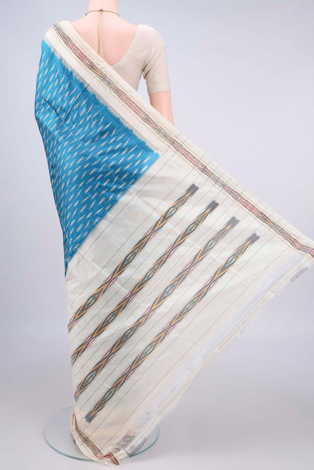 Flat view of Pure Silk Blue Pochampally Saree with Ikat design on the body and Ikat Border. 