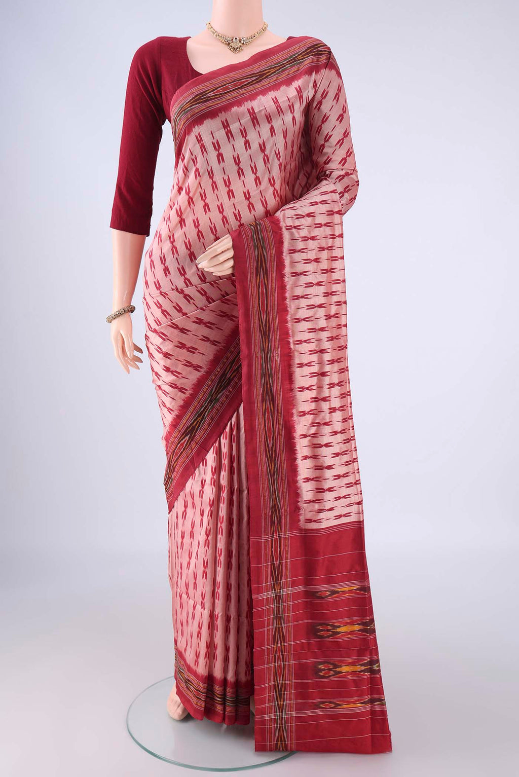 Peach Pochampally Silk Saree with Ikat design on the body and Ikat Border.  displayed on a mannequin
