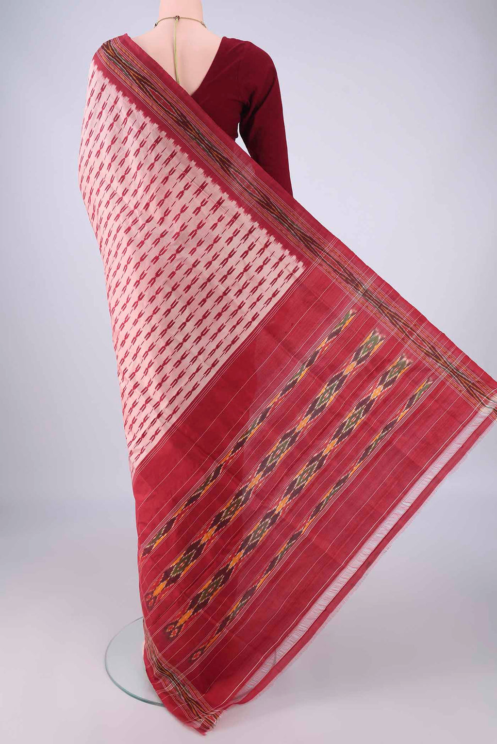 Flat view of Peach Pochampally Silk Saree with Ikat design on the body and Ikat Border. 