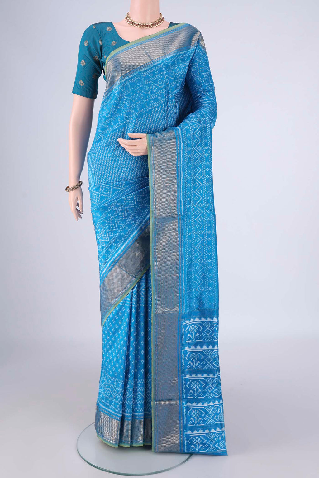 Electric Blue Pochampally Silk Saree with Pure Ikat on the body and Zari Border.  displayed on a mannequin