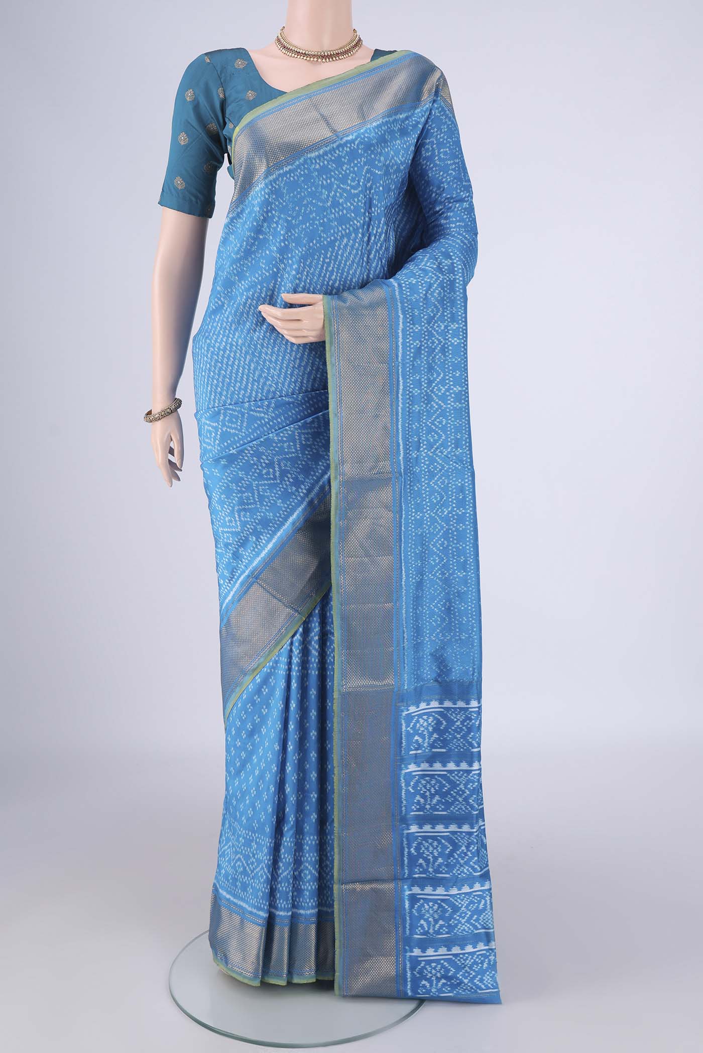 Electric Blue Pochampally Silk Saree with Pure Ikat on the body and Zari Border.  displayed on a mannequin