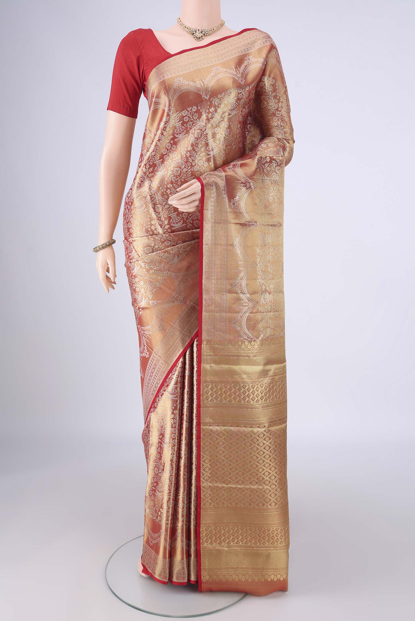 Gold with Red Color Kanjivaram Silk Saree with Zari Brocade on the body and Zari Border.  displayed on a mannequin