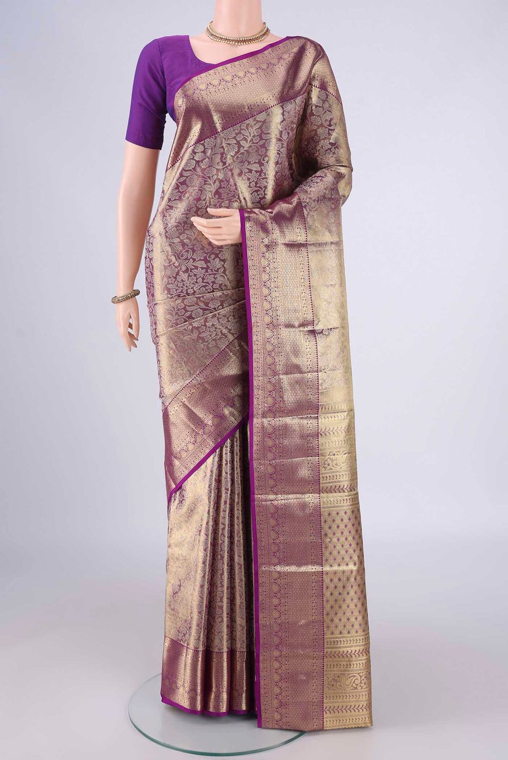 Golden Kanjivaram Silk Saree with Zari Brocade on the body and Zari Border.  displayed on a mannequin