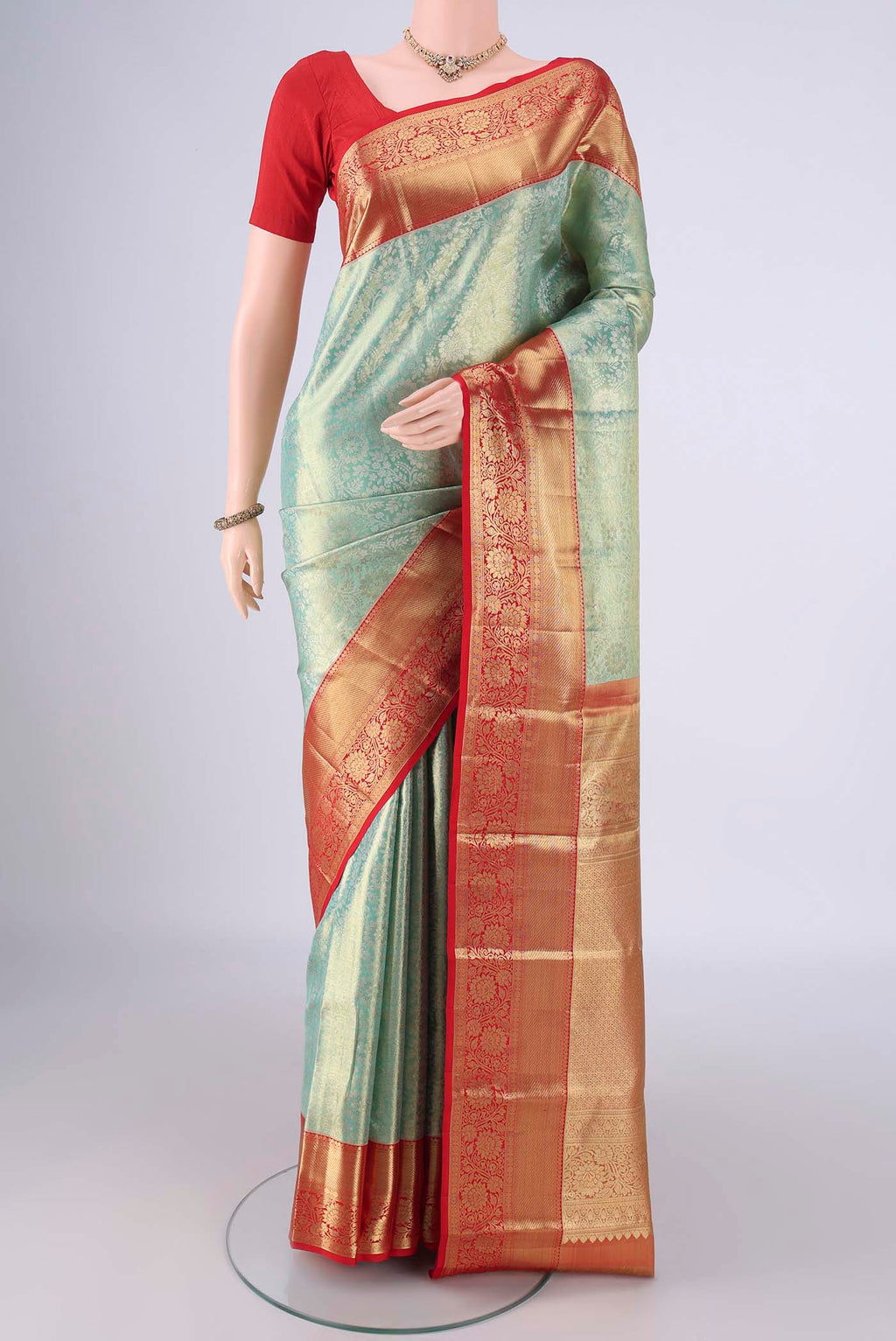 Mint Green Dual Tone Kanchipuram Tissue Silk Saree with Zari Brocade on the body and Zari Border.  displayed on a mannequin