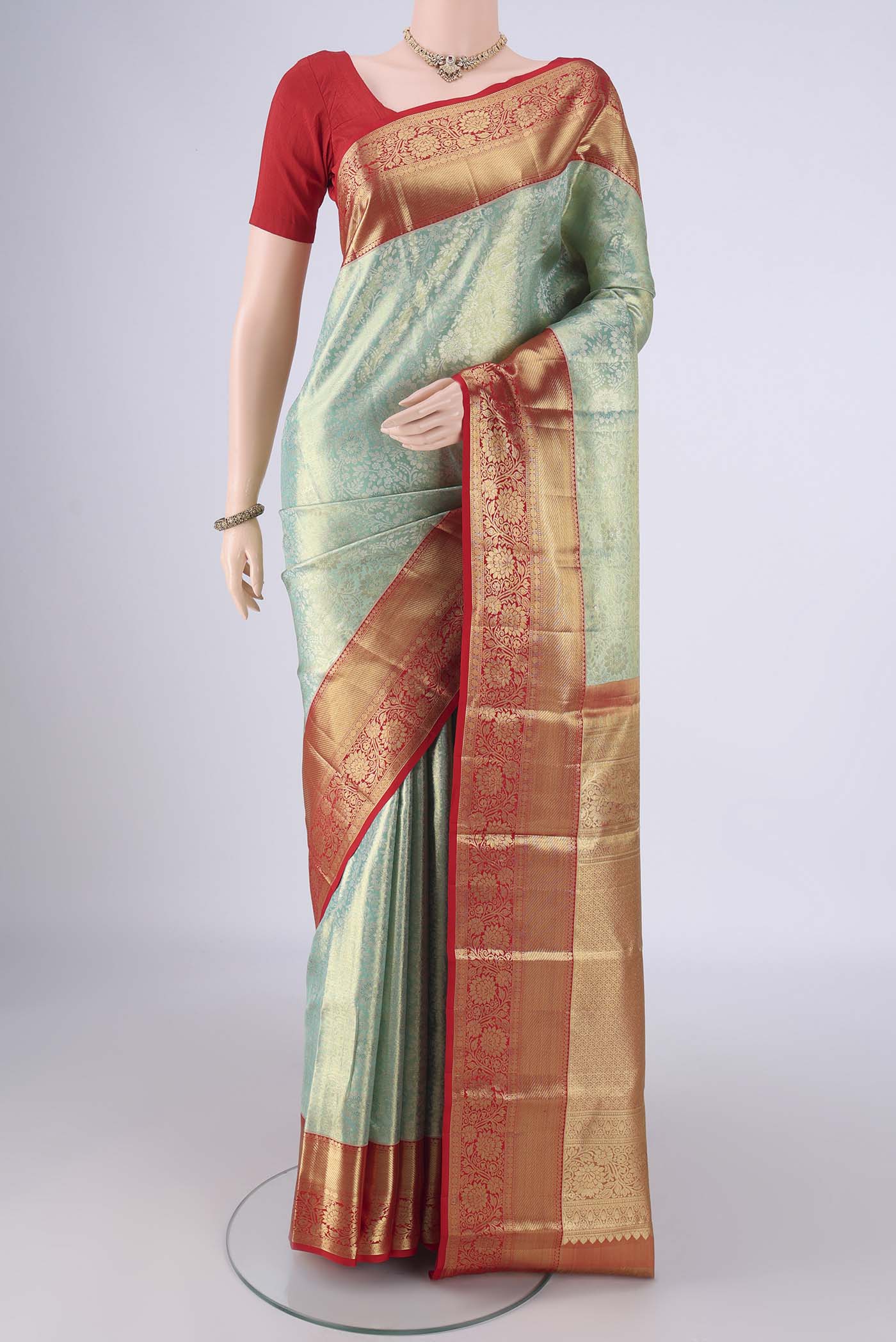 Mint Green Dual Tone Kanchipuram Tissue Silk Saree with Zari Brocade on the body and Zari Border.  displayed on a mannequin