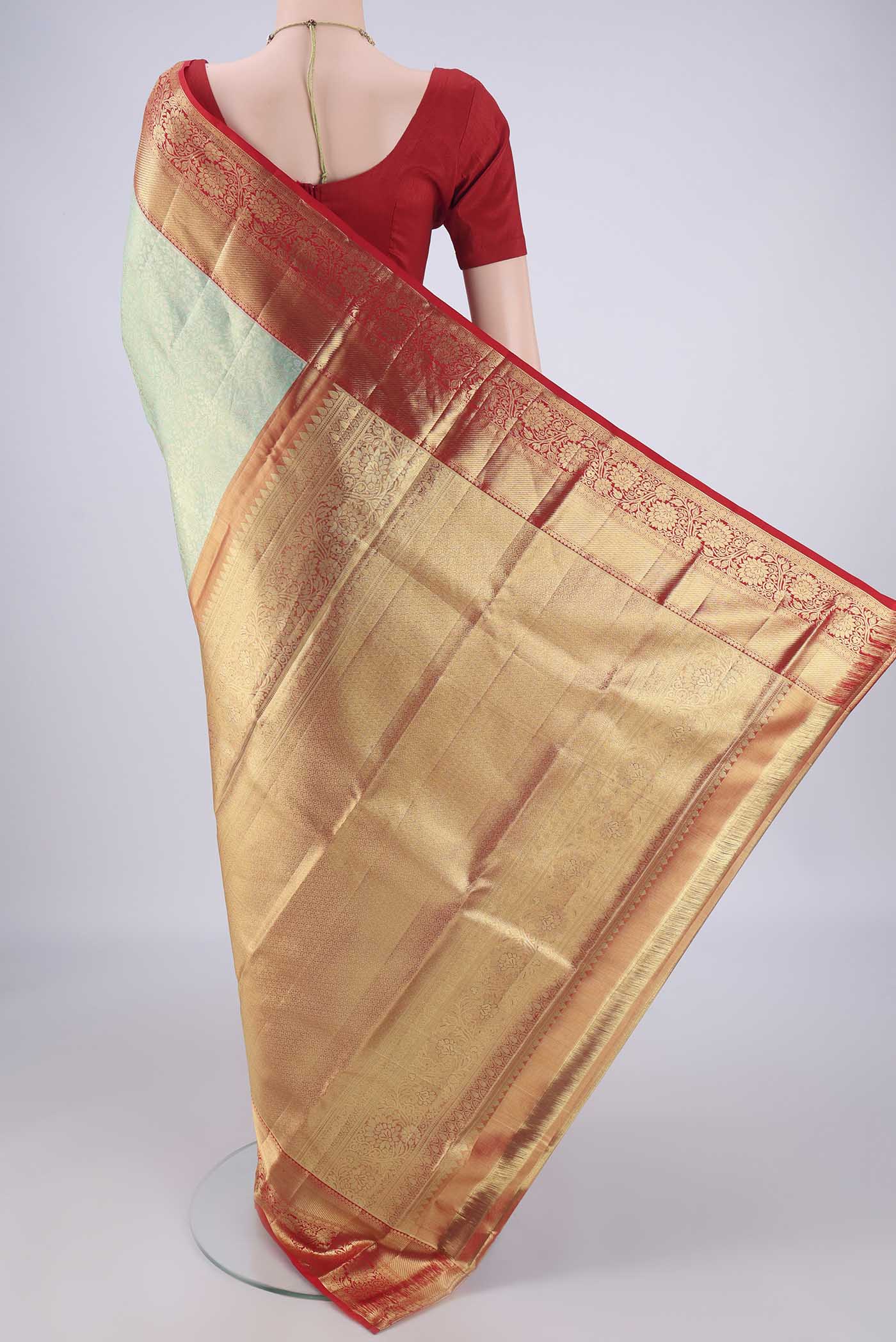 Flat view of Mint Green Dual Tone Kanchipuram Tissue Silk Saree with Zari Brocade on the body and Zari Border. 