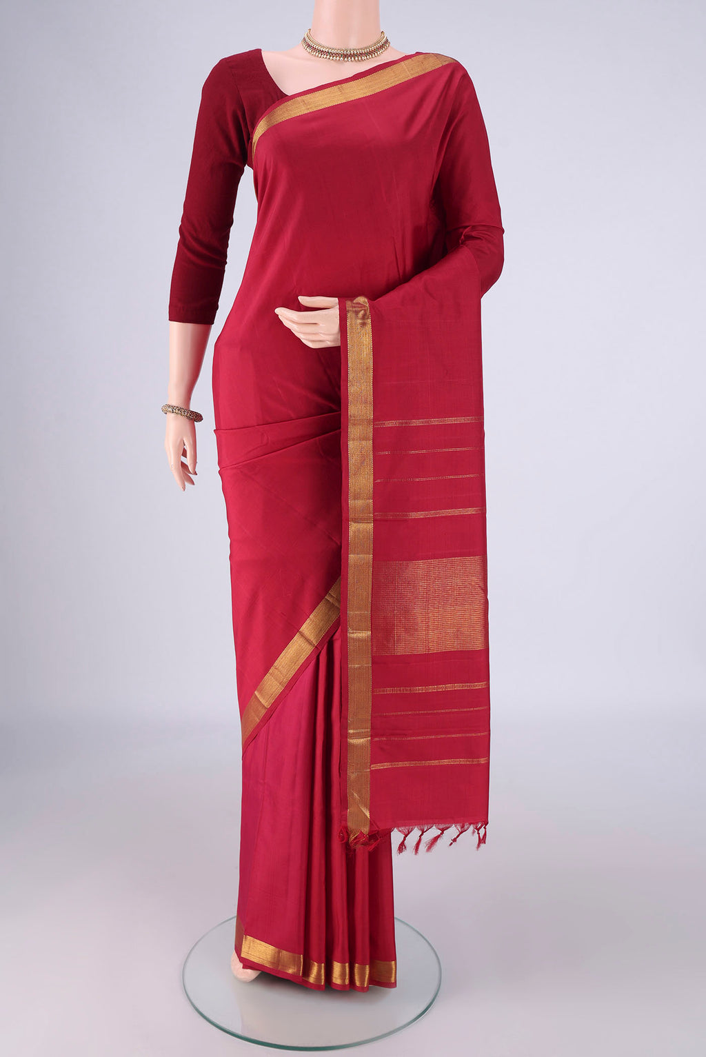 Red Kanjivaram Silk Saree with Plain Body and Zari Border.  displayed on a mannequin