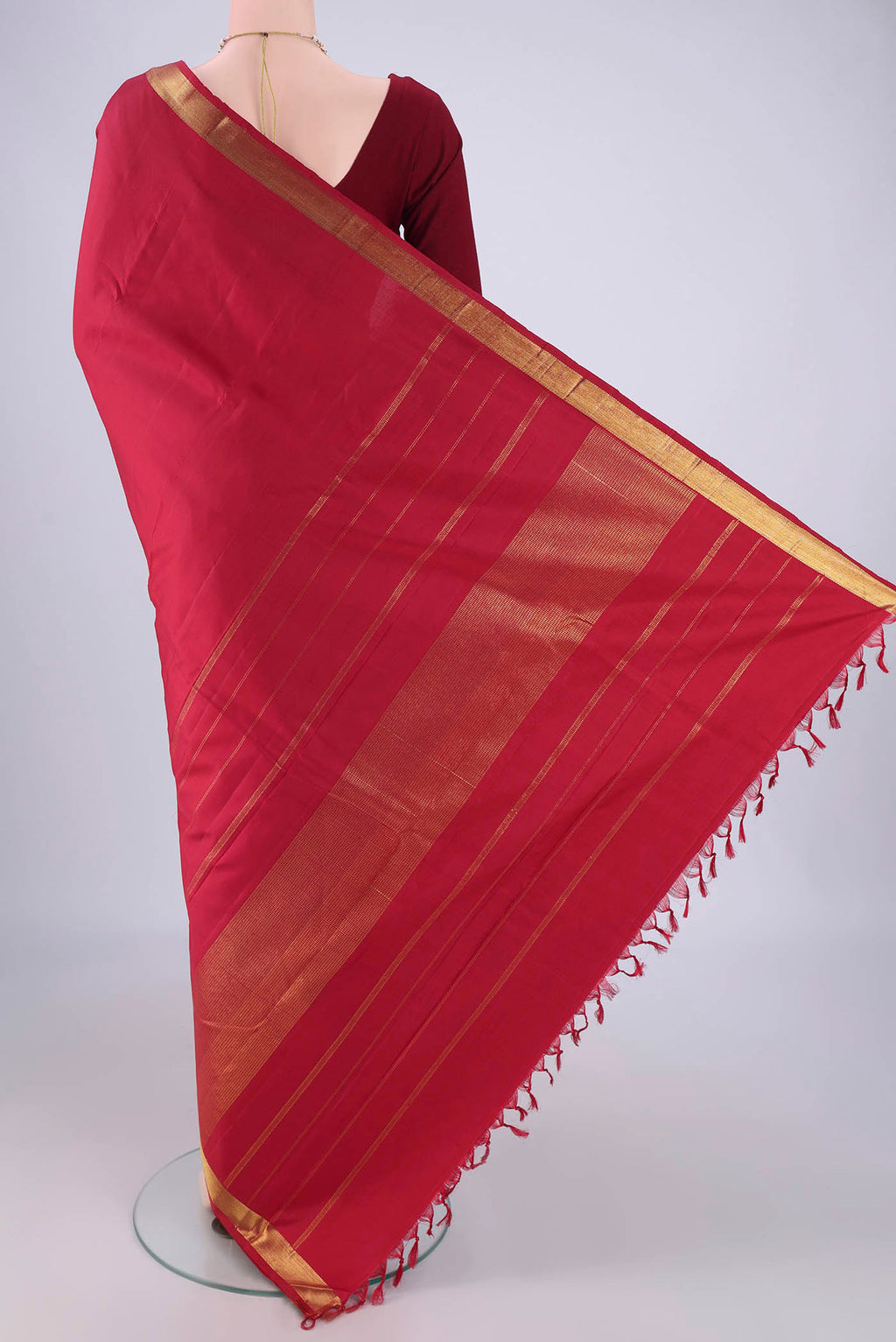Flat view of Red Kanjivaram Silk Saree with Plain Body and Zari Border. 