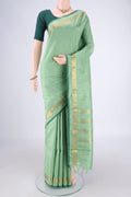 Light Green Kanchipuram Silk Saree with Zari Butta on the body and Zari Border.  displayed on a mannequin