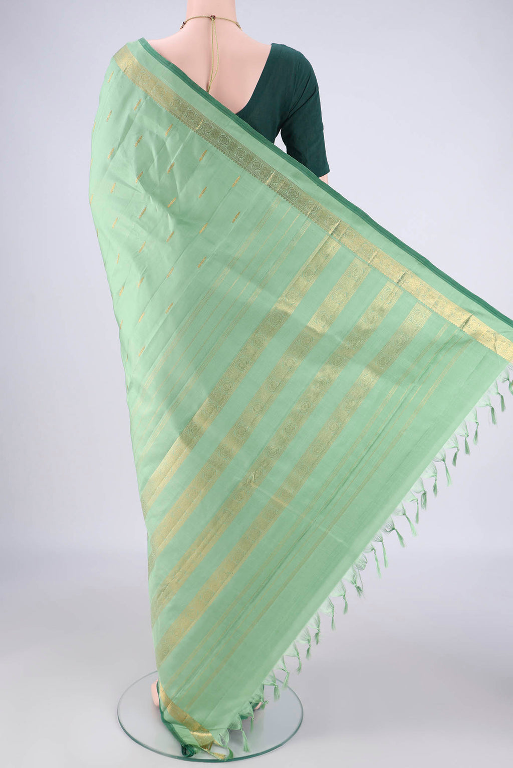 Flat view of Light Green Kanchipuram Silk Saree with Zari Butta on the body and Zari Border. 