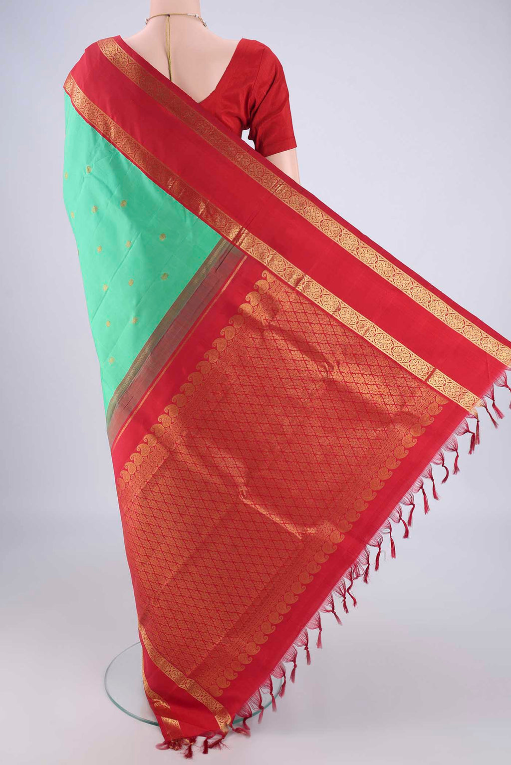 Flat view of Green Dual Tone Kanjivaram Silk Saree with Zari Butta on the body and Zari Border. 