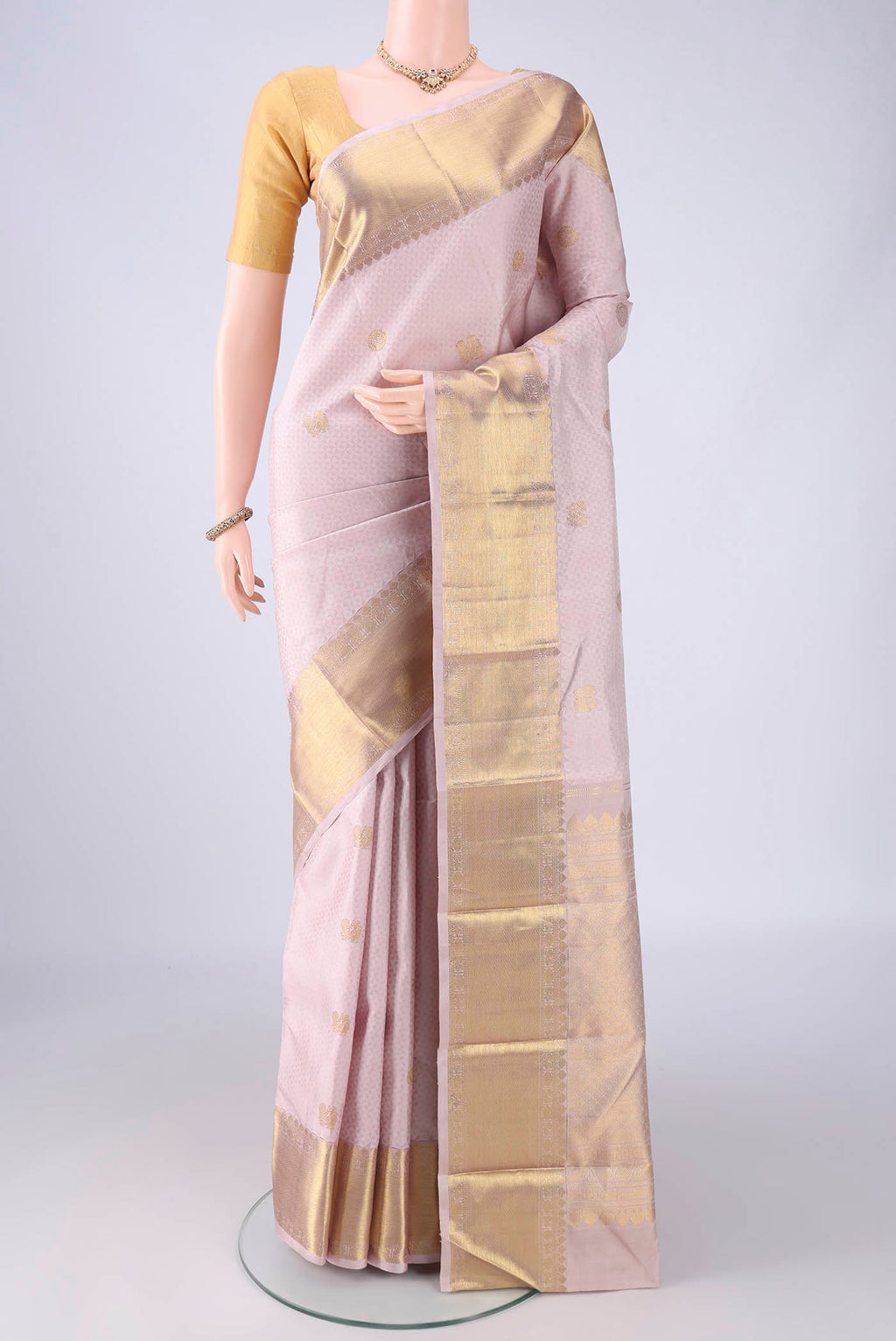Rose Gold Kanjivaram Silk Saree with Jacquard With Zari Butta on the body and Zari Border.  displayed on a mannequin