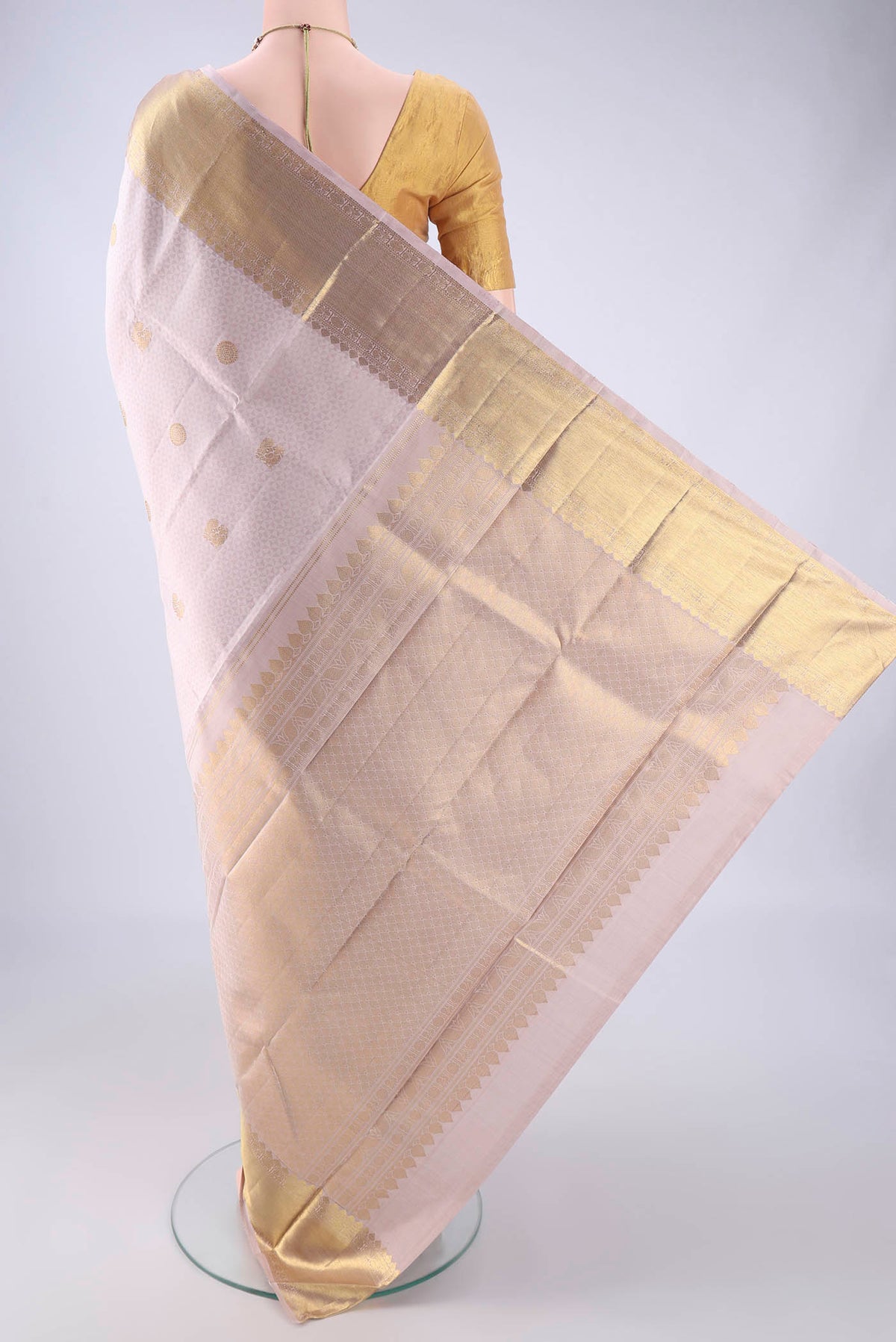 Flat view of Rose Gold Kanjivaram Silk Saree with Jacquard With Zari Butta on the body and Zari Border. 