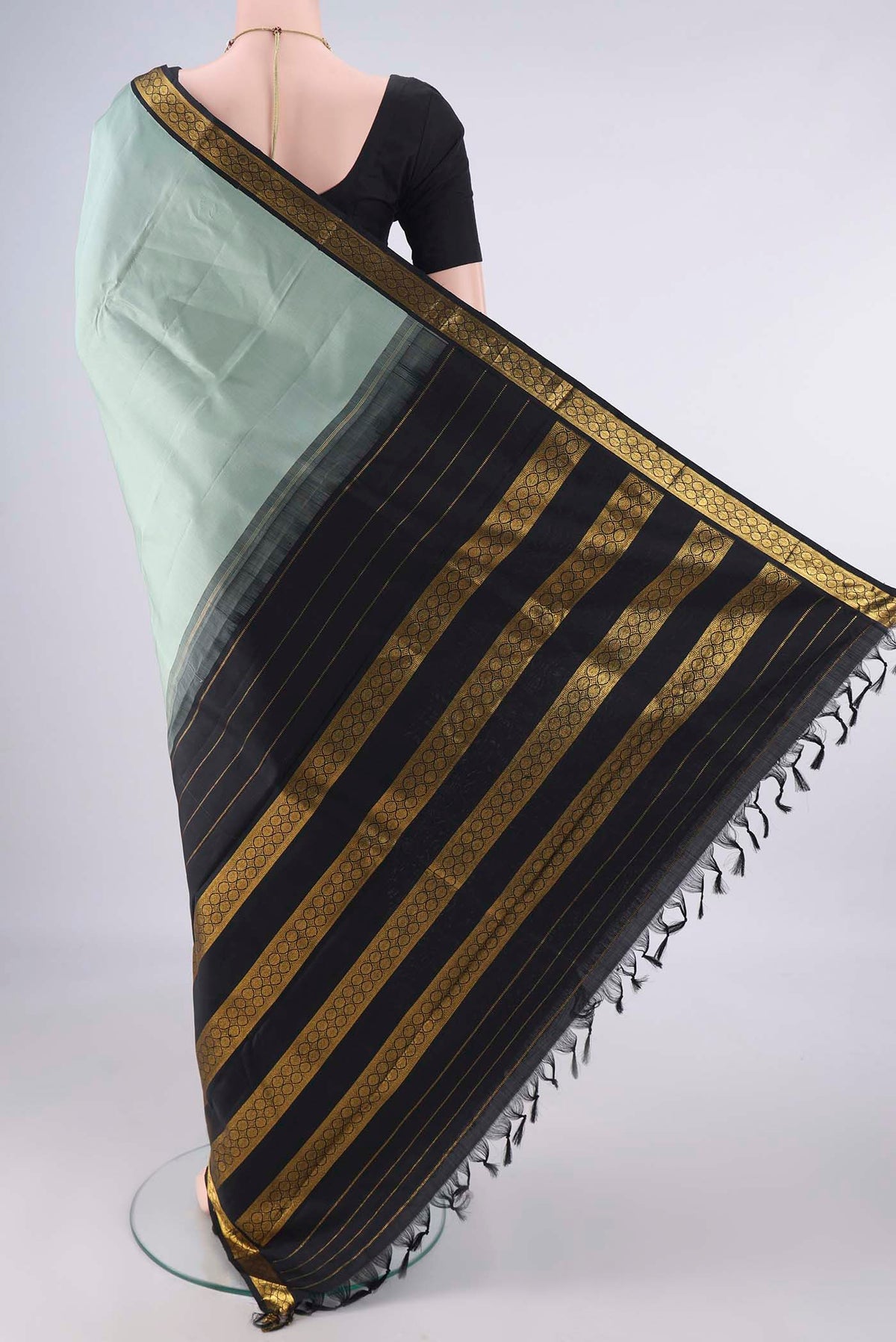 Flat view of Pure Silk Sage Green Kanjivaram Saree with Plain Body and Zari Border. 