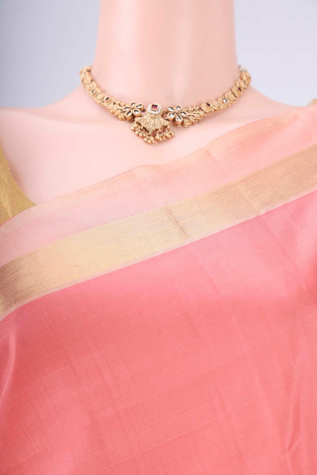 Border image of Peach Kanchipuram Silk Saree with Plain Body and Zari Border. 