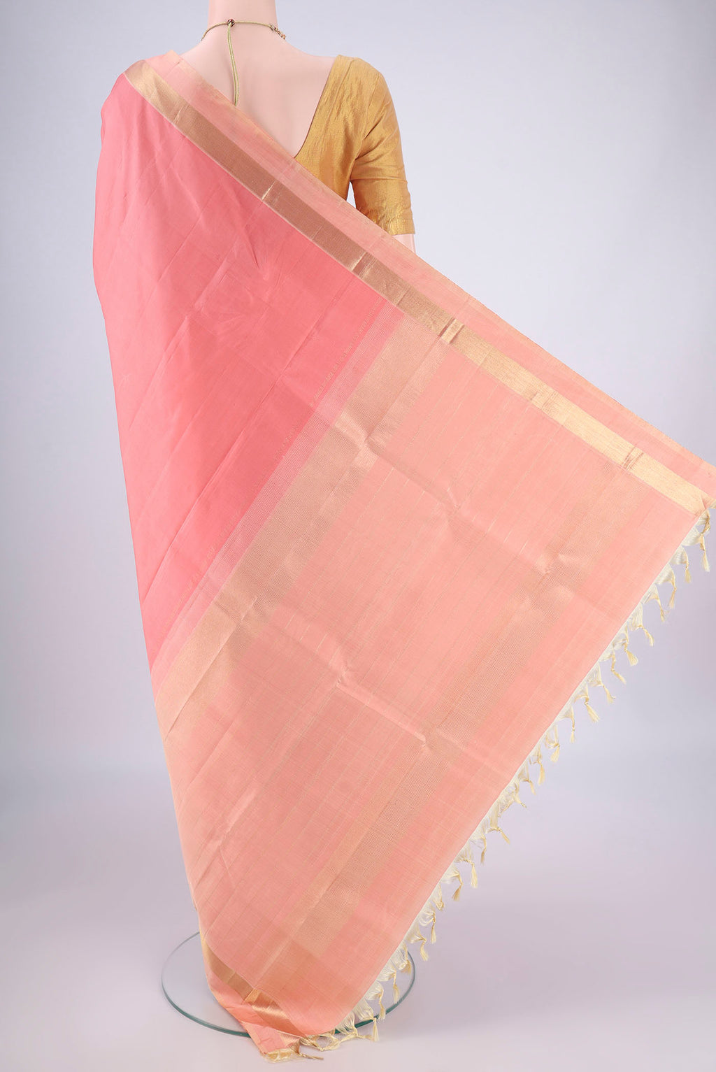 Flat view of Peach Kanchipuram Silk Saree with Plain Body and Zari Border. 
