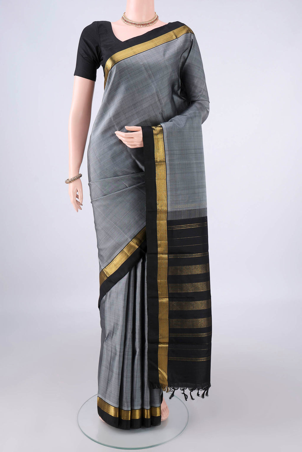 Pure Silk Grey Kanchipuram Saree with Plain Body and Zari Border.  displayed on a mannequin