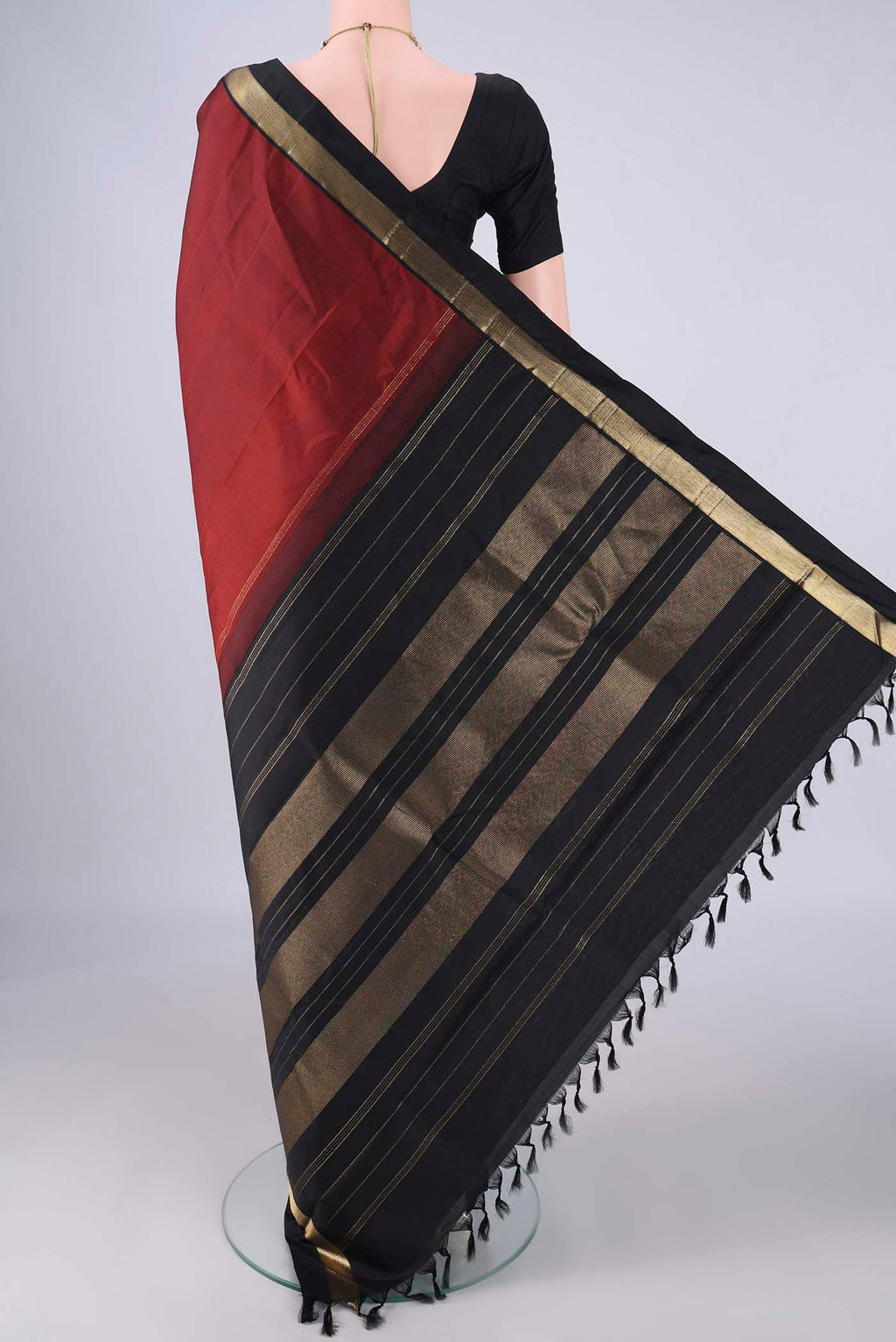 Flat view of Rust Kanchipuram Silk Saree with Plain Body and Zari Border. 