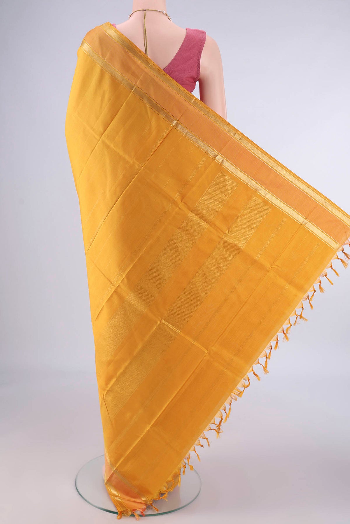 Flat view of Pure Silk Mustard Kanchipuram Saree with Plain Body and Zari Border. 