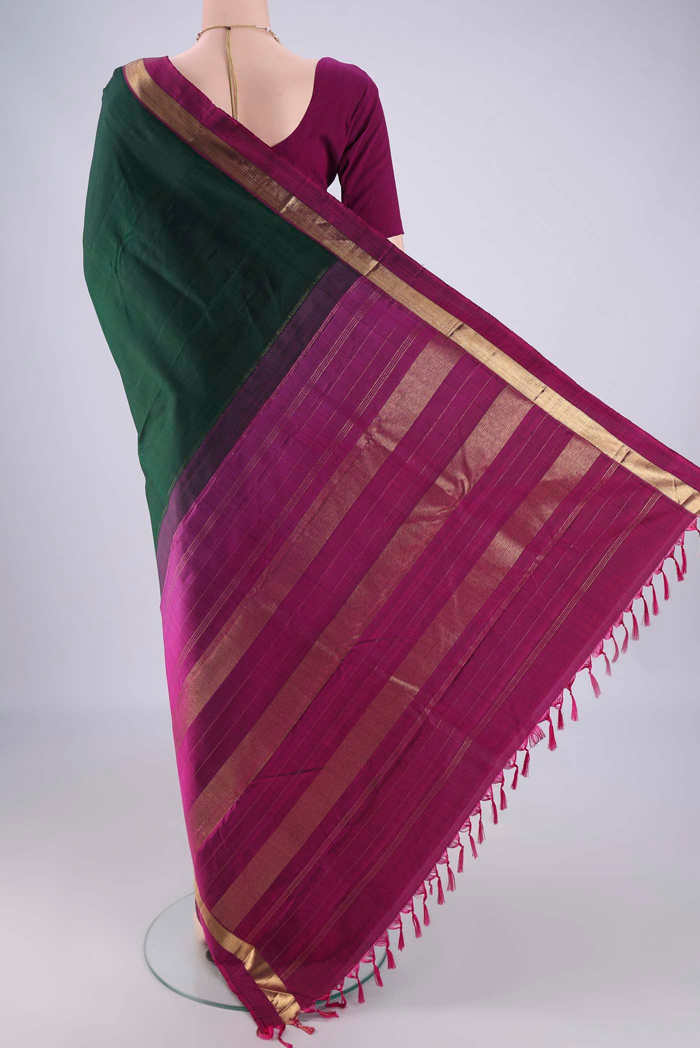 Flat view of Bottle Green Kanchipuram Silk Saree with Plain Body and Zari Border. 