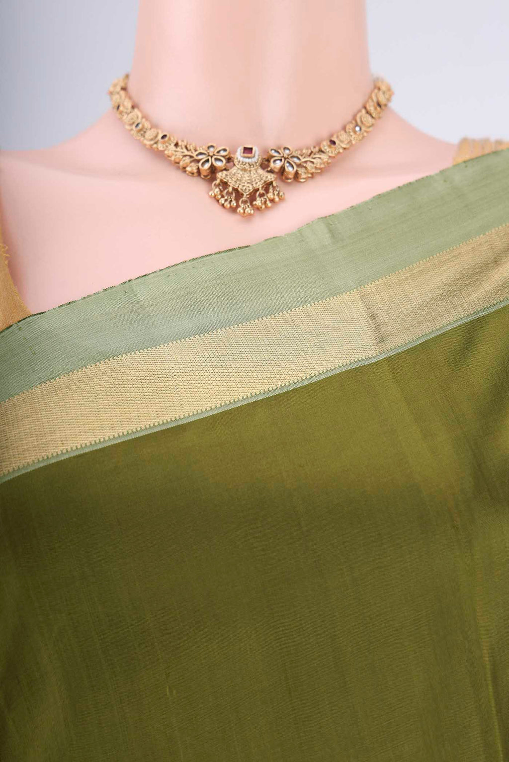 Border image of Mehandi Green Kanchipuram Silk Saree with Plain Body and Zari Border. 