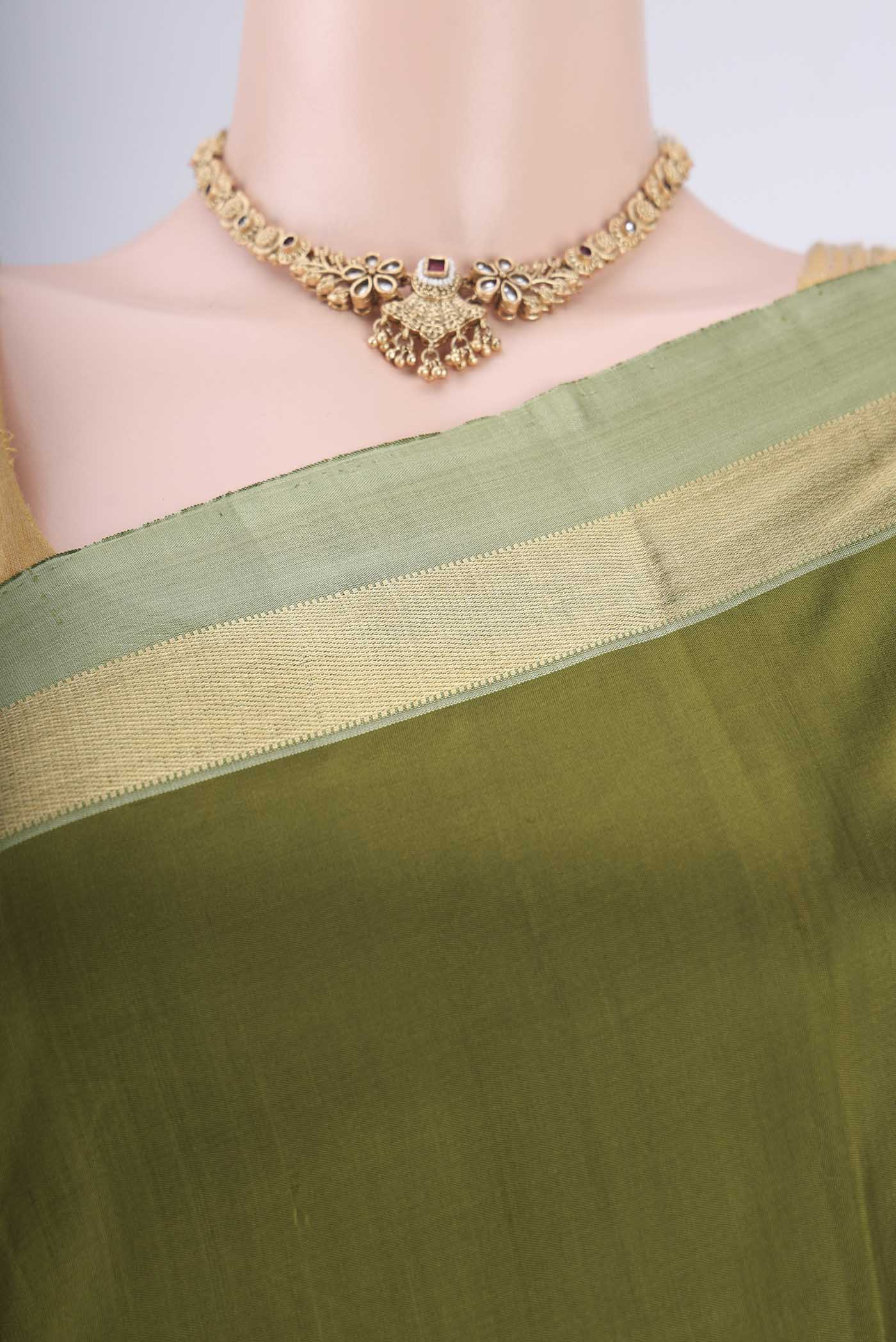 Border image of Mehandi Green Kanchipuram Silk Saree with Plain Body and Zari Border. 