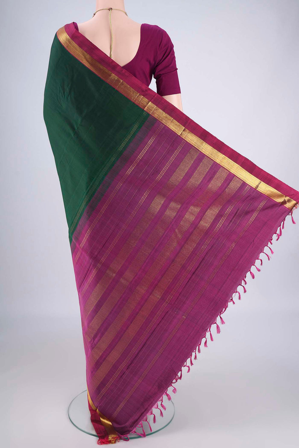 Flat view of Bottle Green Kanchipuram Silk Saree with Plain Body and Zari Border. 