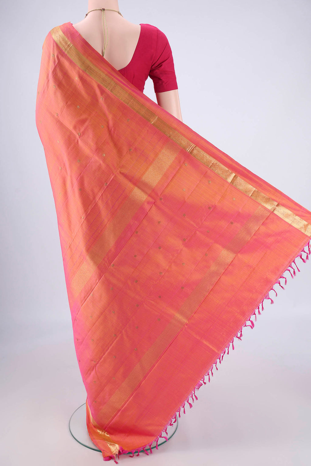 Flat view of Pinkish Yellow Kanjivaram Silk Saree with Zari Butta on the body and Zari Border. 