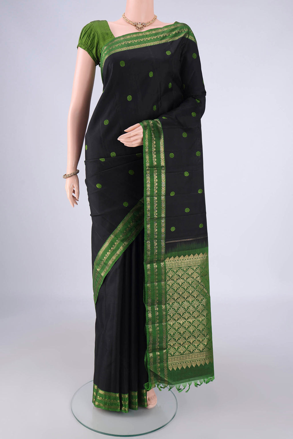 Black Dual Tone Kanchipuram Silk Saree with Thread Butta on the body and Zari Border.  displayed on a mannequin