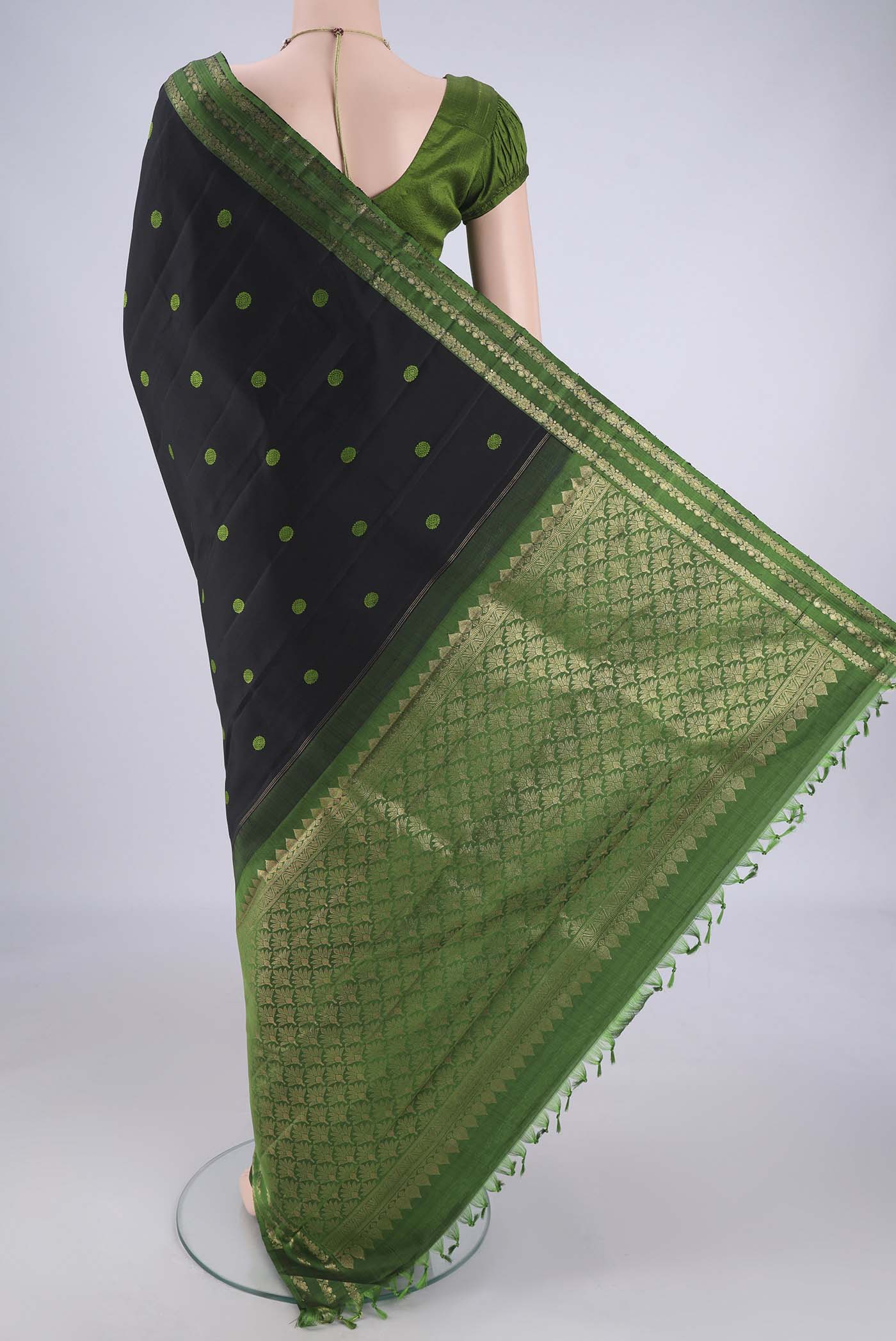 Flat view of Black Dual Tone Kanchipuram Silk Saree with Thread Butta on the body and Zari Border. 