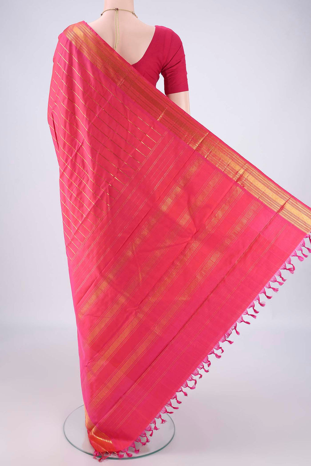 Flat view of Dark Pink Kanchipuram Silk Saree with Stripes on the body and Thin Zari Line. 