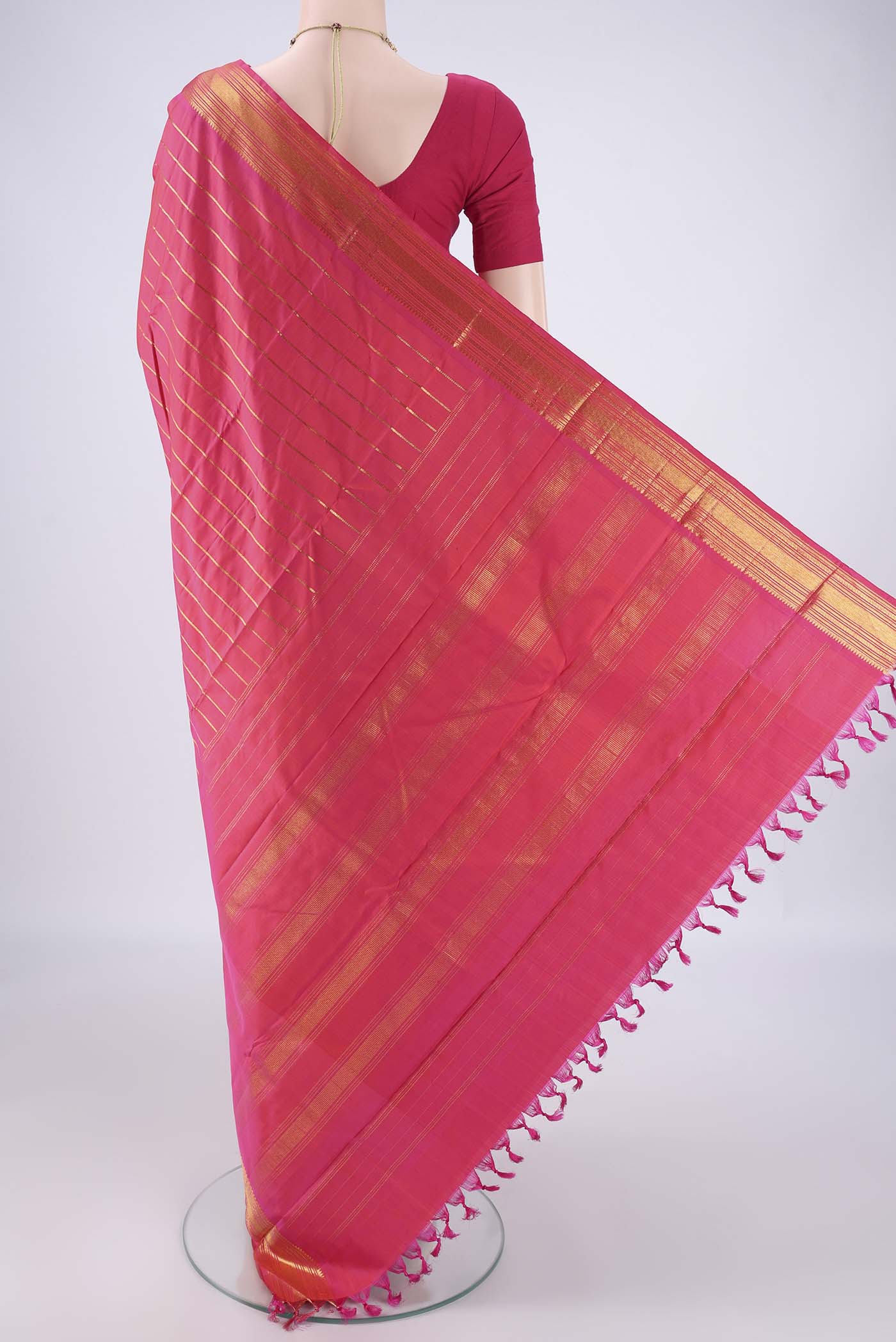 Flat view of Dark Pink Kanchipuram Silk Saree with Stripes on the body and Thin Zari Line. 