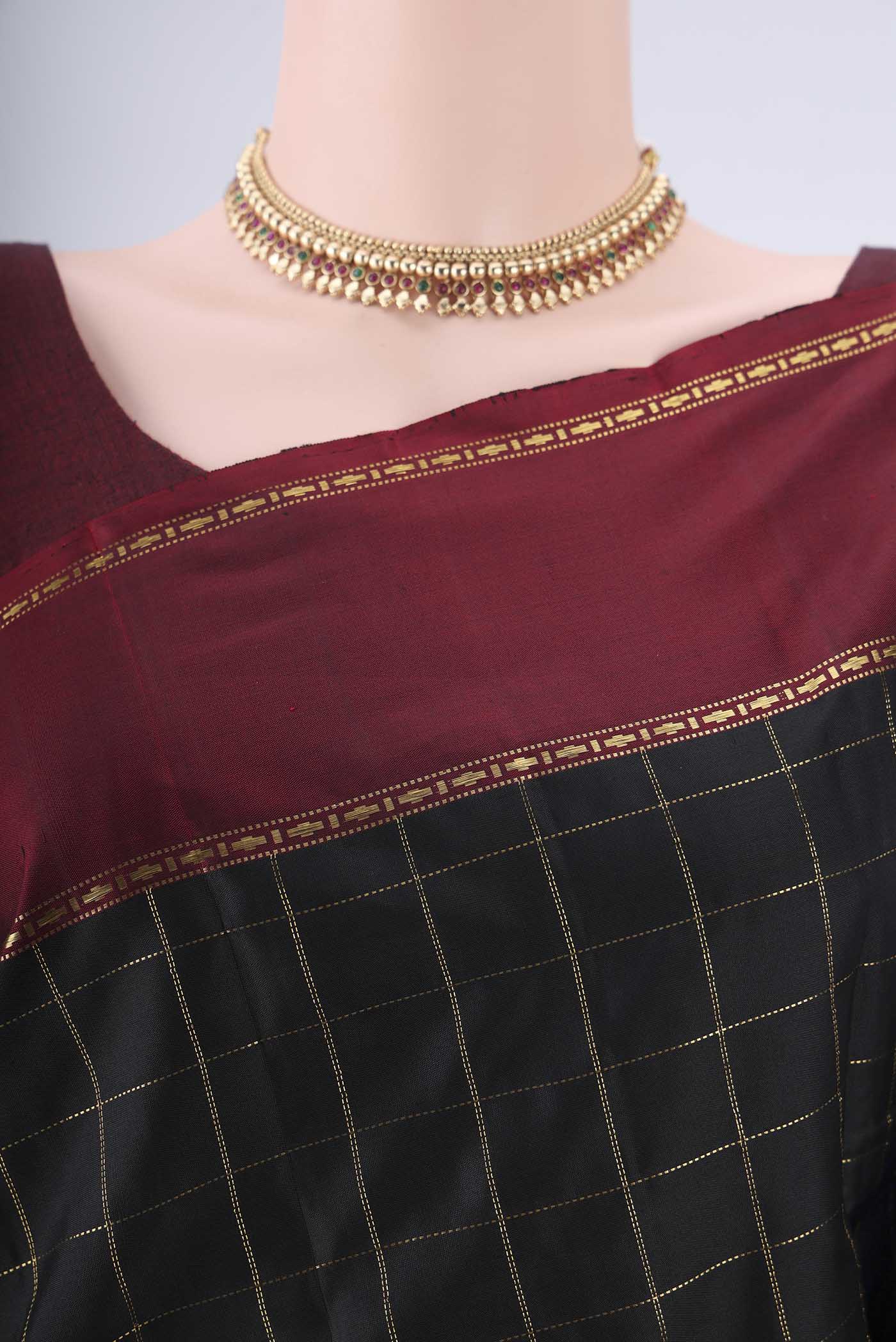 Border image of Black Kanchipuram Silk Saree with Checked design on the body and Thin Zari Line. 