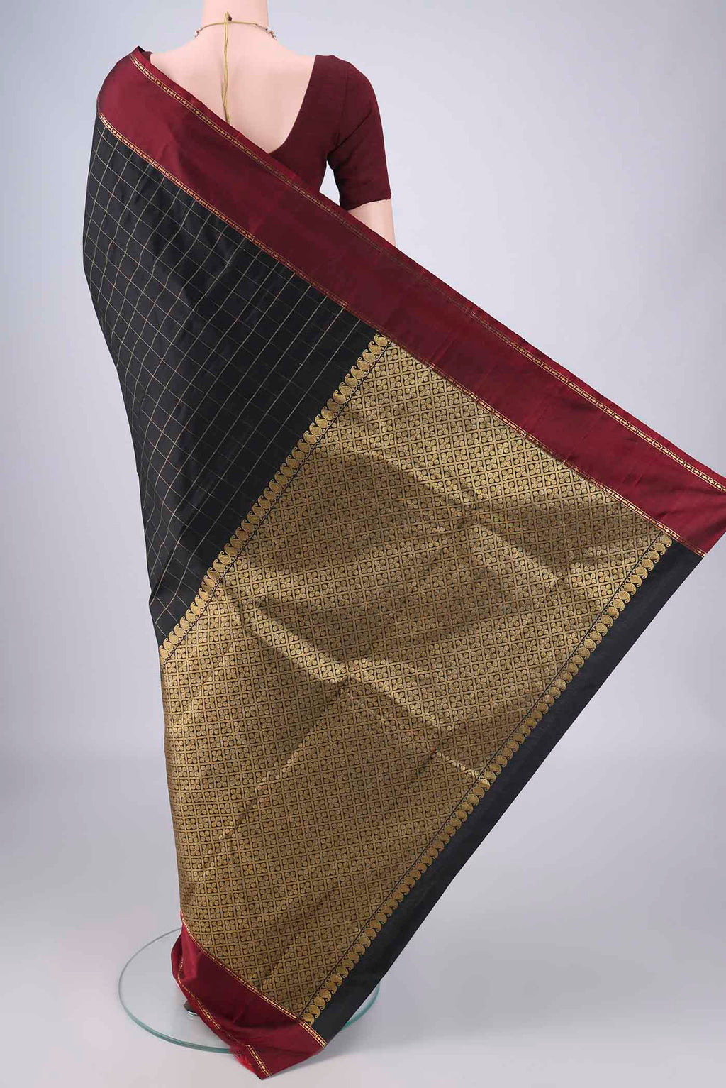 Flat view of Black Kanchipuram Silk Saree with Checked design on the body and Thin Zari Line. 