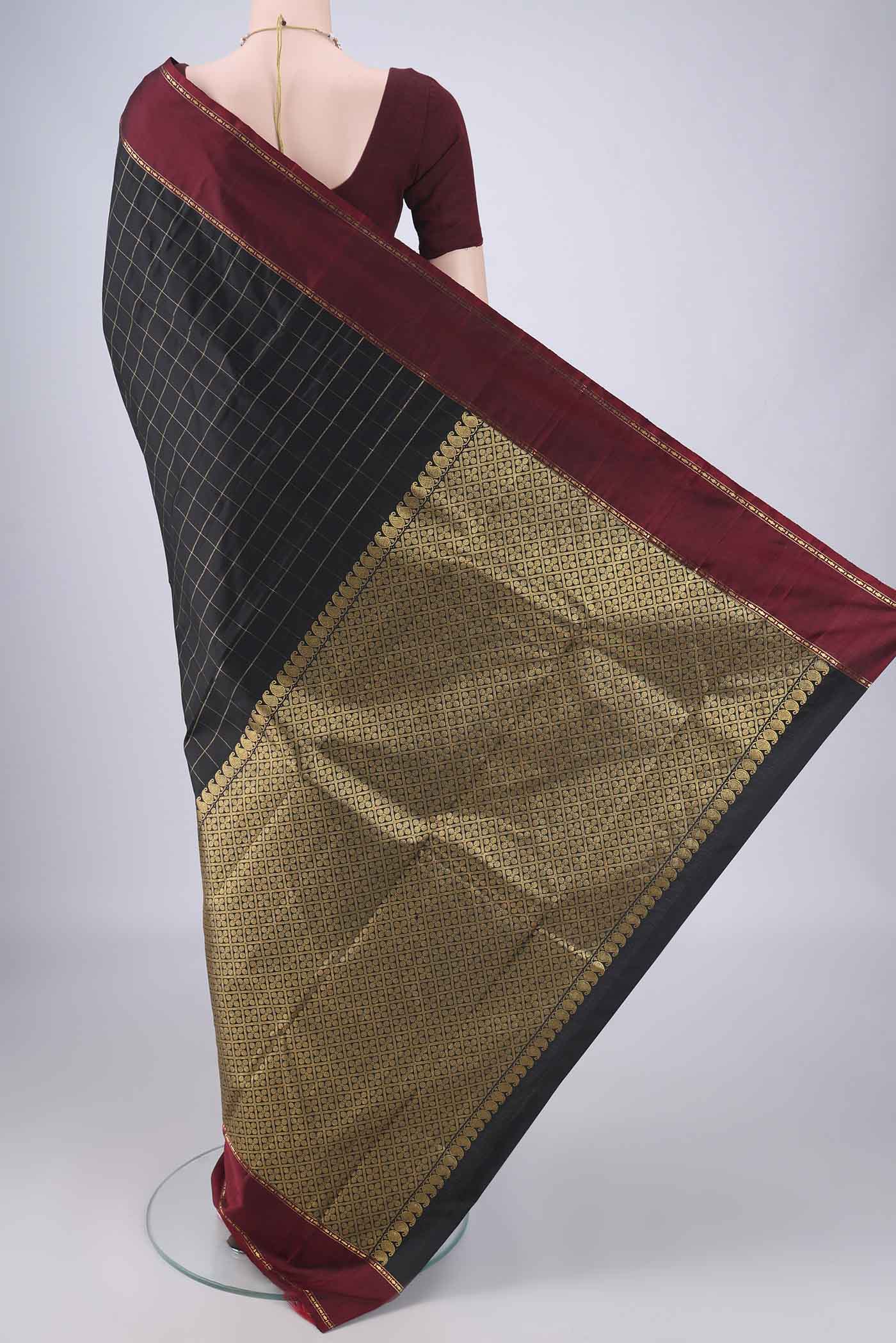 Flat view of Black Kanchipuram Silk Saree with Checked design on the body and Thin Zari Line. 