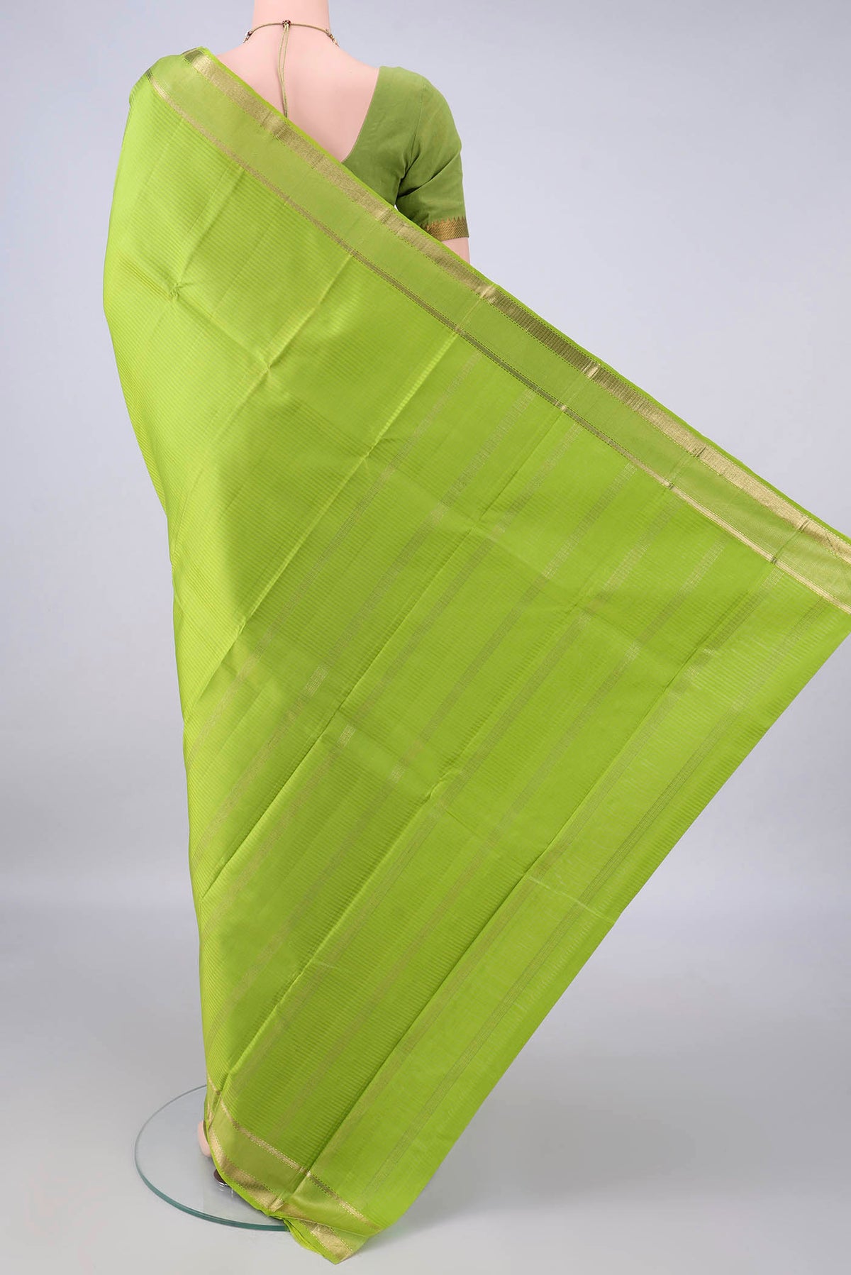Flat view of Pure Silk Parrot Green Kanjivaram Saree with Stripes on the body and Zari Border. 