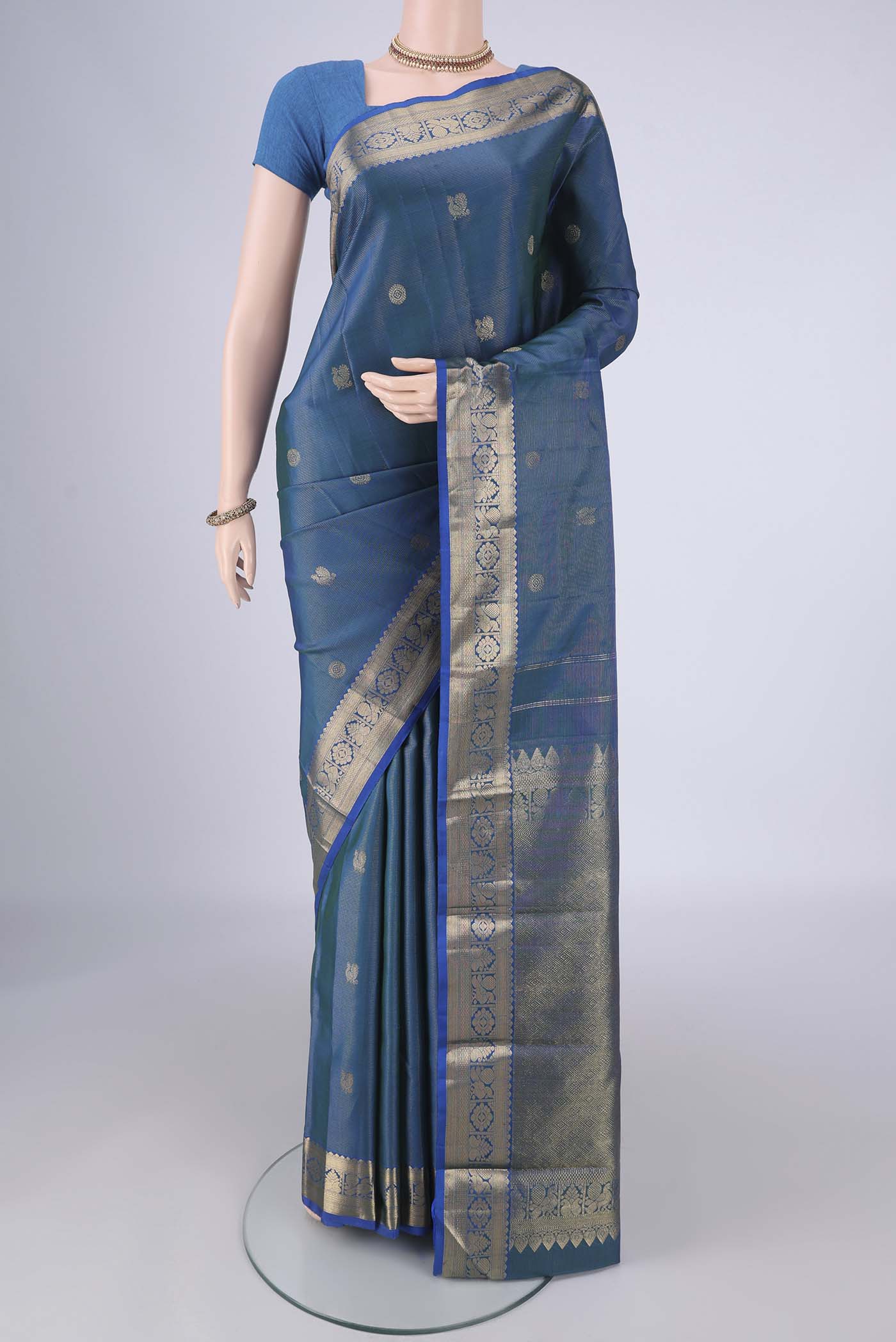 Blue Kanjivaram Silk Saree with Zari Brocade on the body and Zari Border.  displayed on a mannequin