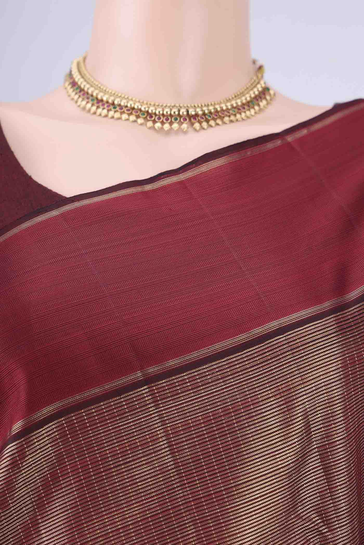 Border image of Maroon Kanjivaram Silk Saree with Zari Brocade on the body and Zari Border. 