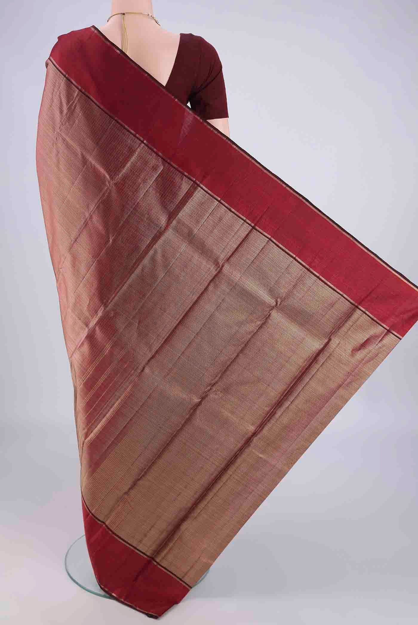Flat view of Maroon Kanjivaram Silk Saree with Zari Brocade on the body and Zari Border. 