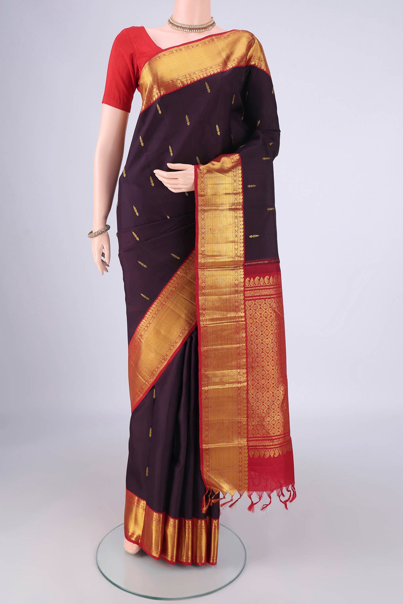 Brown Dual Tone Kanjivaram Silk Saree with Zari Butta on the body and Zari Border.  displayed on a mannequin