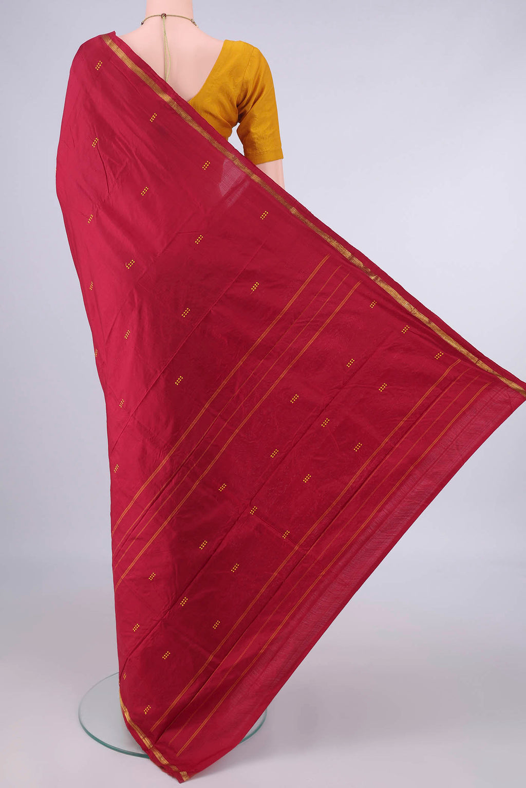 Flat view of Pure Silk Deep Red Kanchipuram Saree with Thread Butta on the body and Zari Border. 