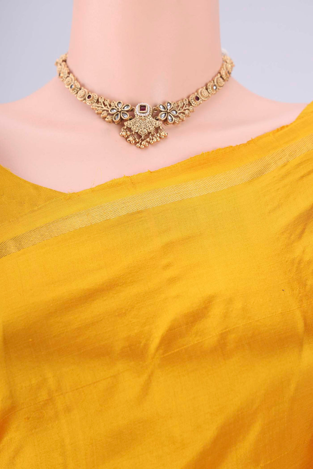 Border image of Yellow Kanchipuram Silk Saree with Thread Butta on the body and Zari Border. 